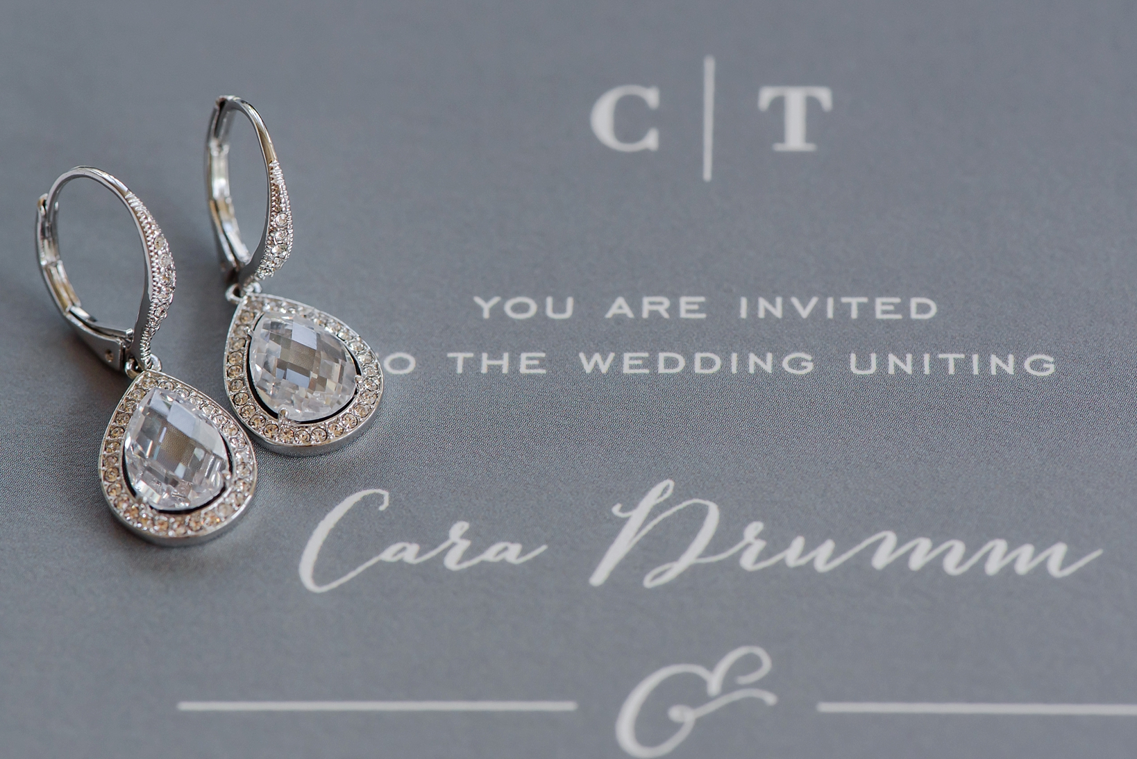 Bridal Earrings against an invitation background