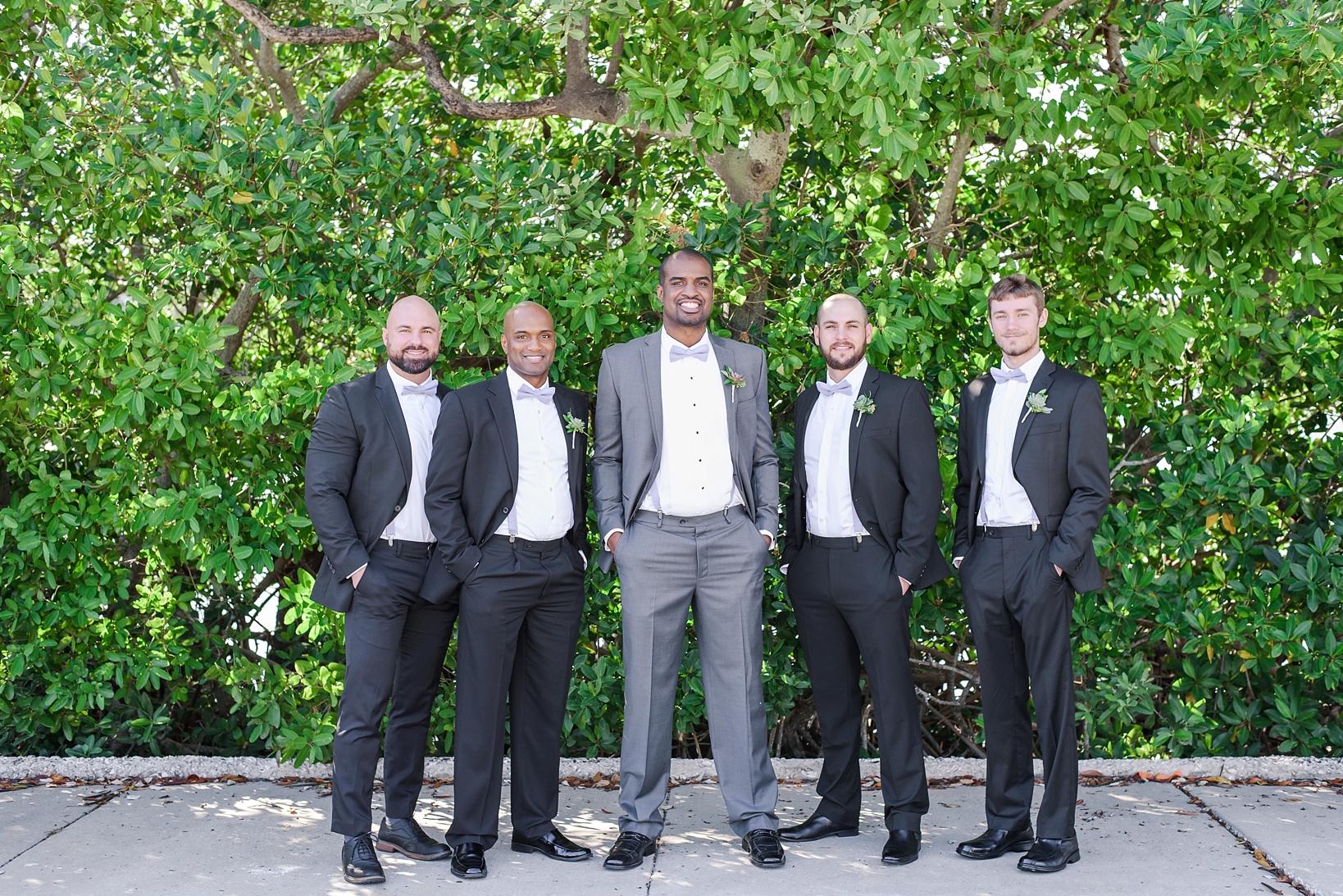 Groom and Groomsmen in front of greenery