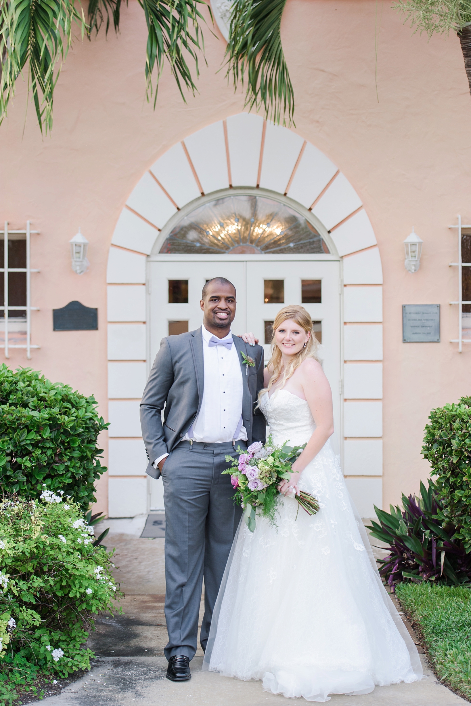 Timeless portrait of the Bride and Groom in front of the reception building