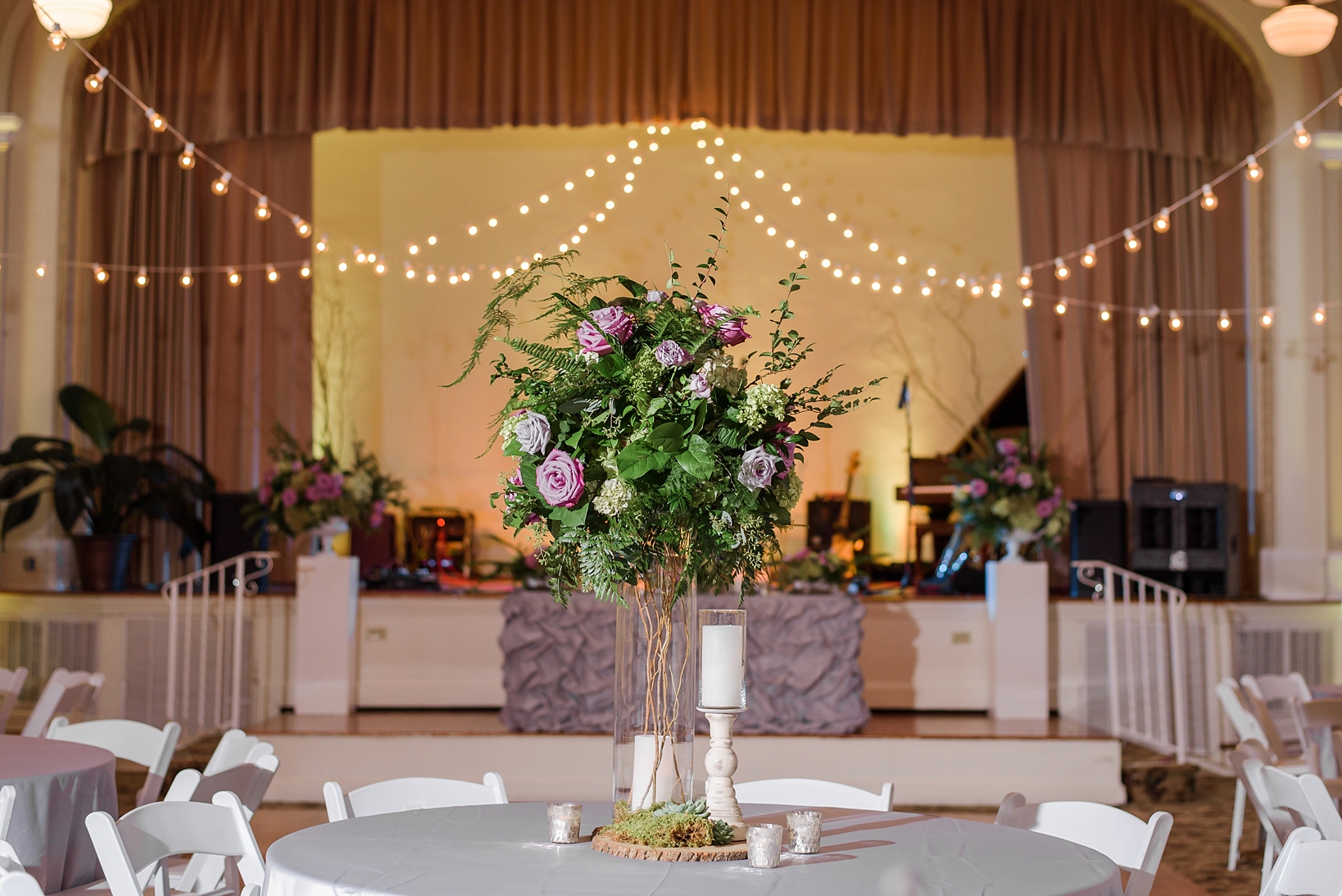 Reception details with string lights and floral centerpieces