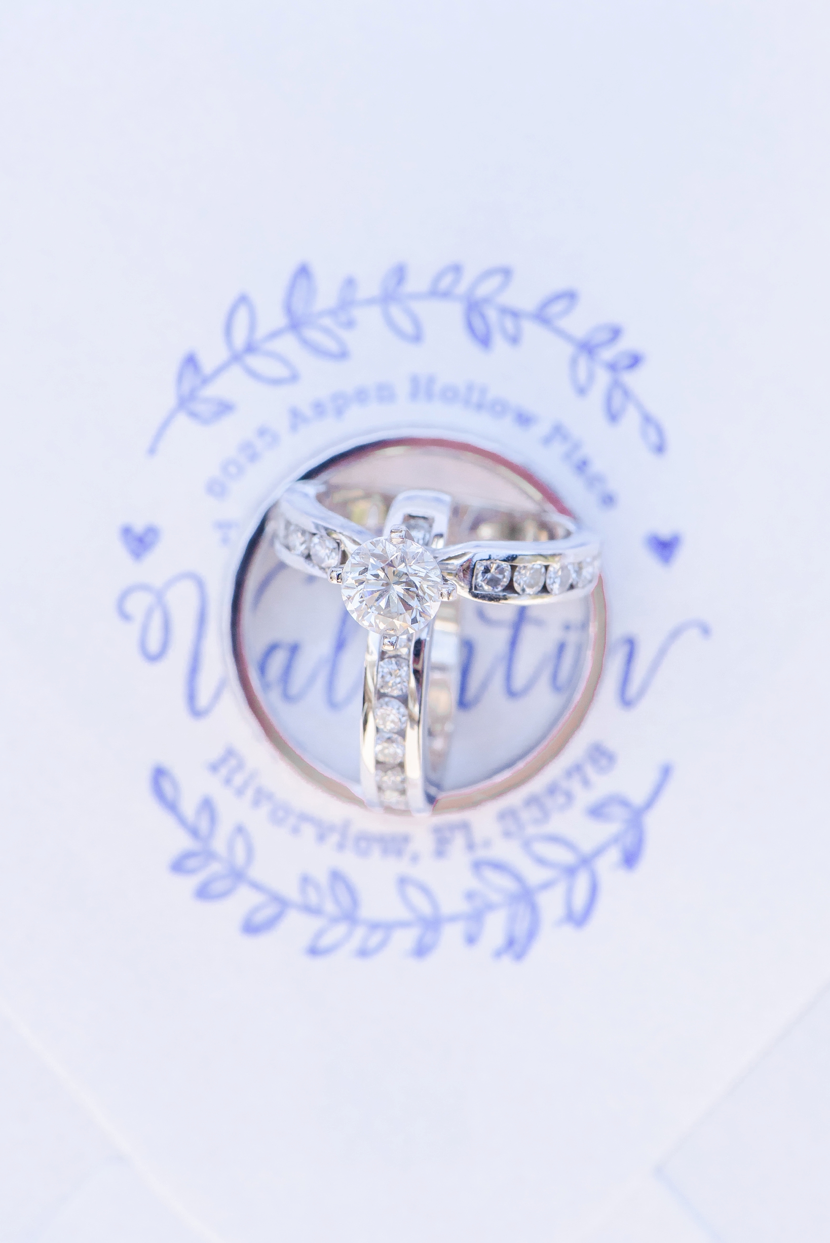 Wedding rings on top of a custom stamp of the new mr and mrs last name by Sarah & Ben