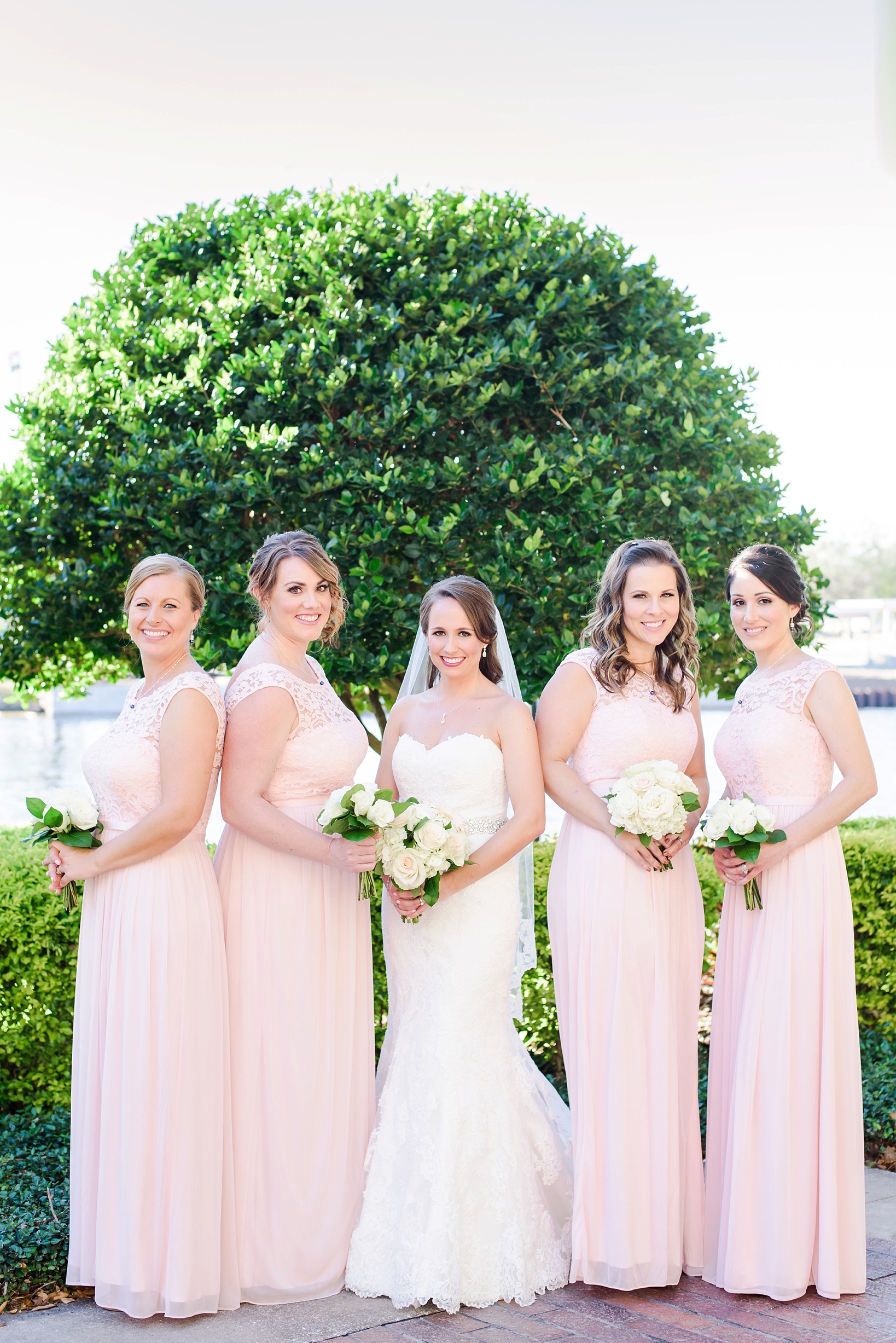 Bride with her Bridesmaids all holding flowers