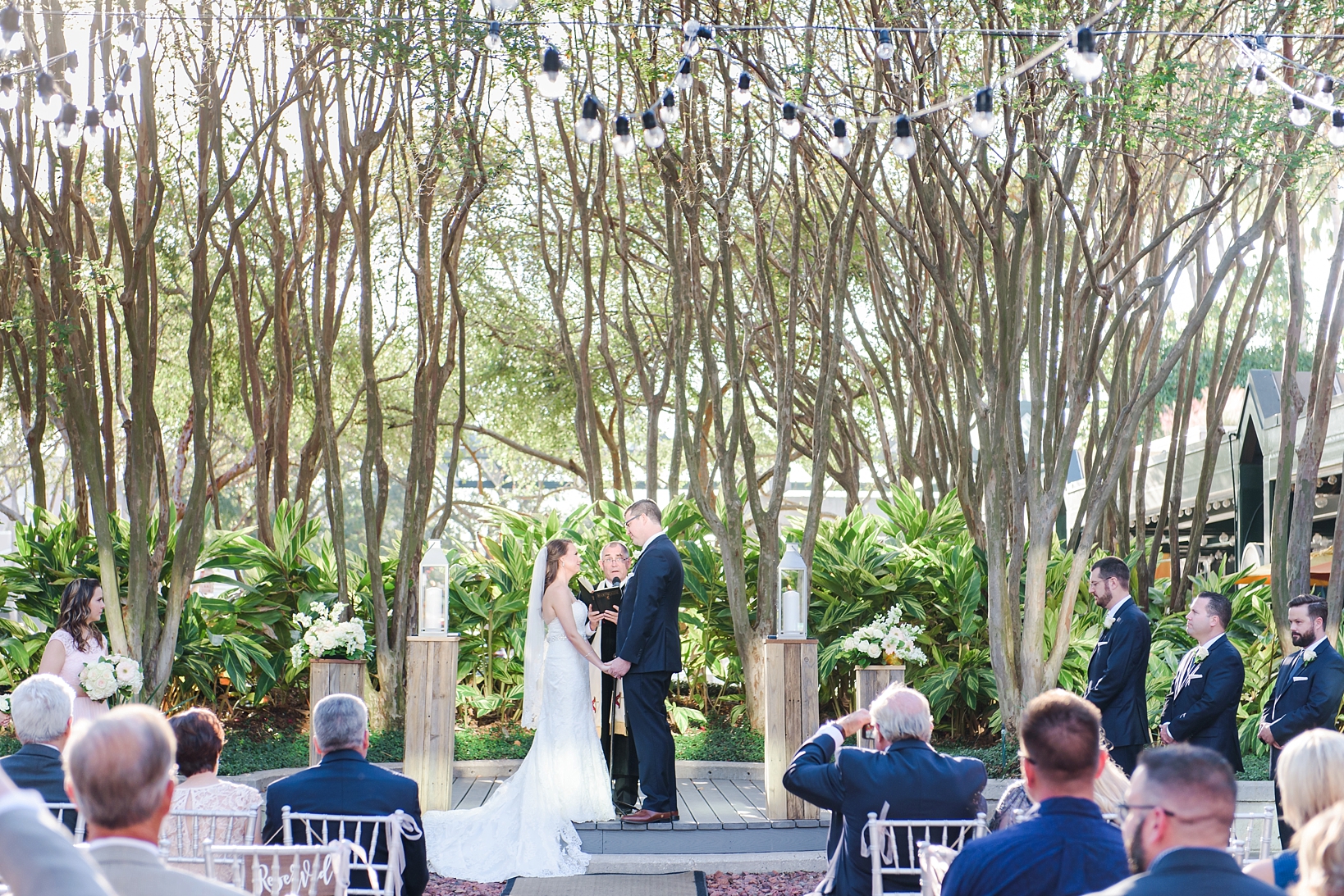The bride and groom at the altar during their ceremony in the Jaeb Courtyard in Tampa, FL by Sarah & Ben Photography