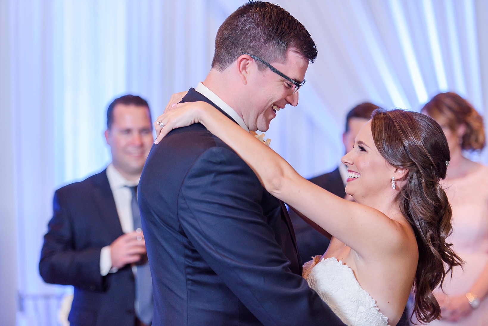 Bride and Groom smiling at each other during their first dance