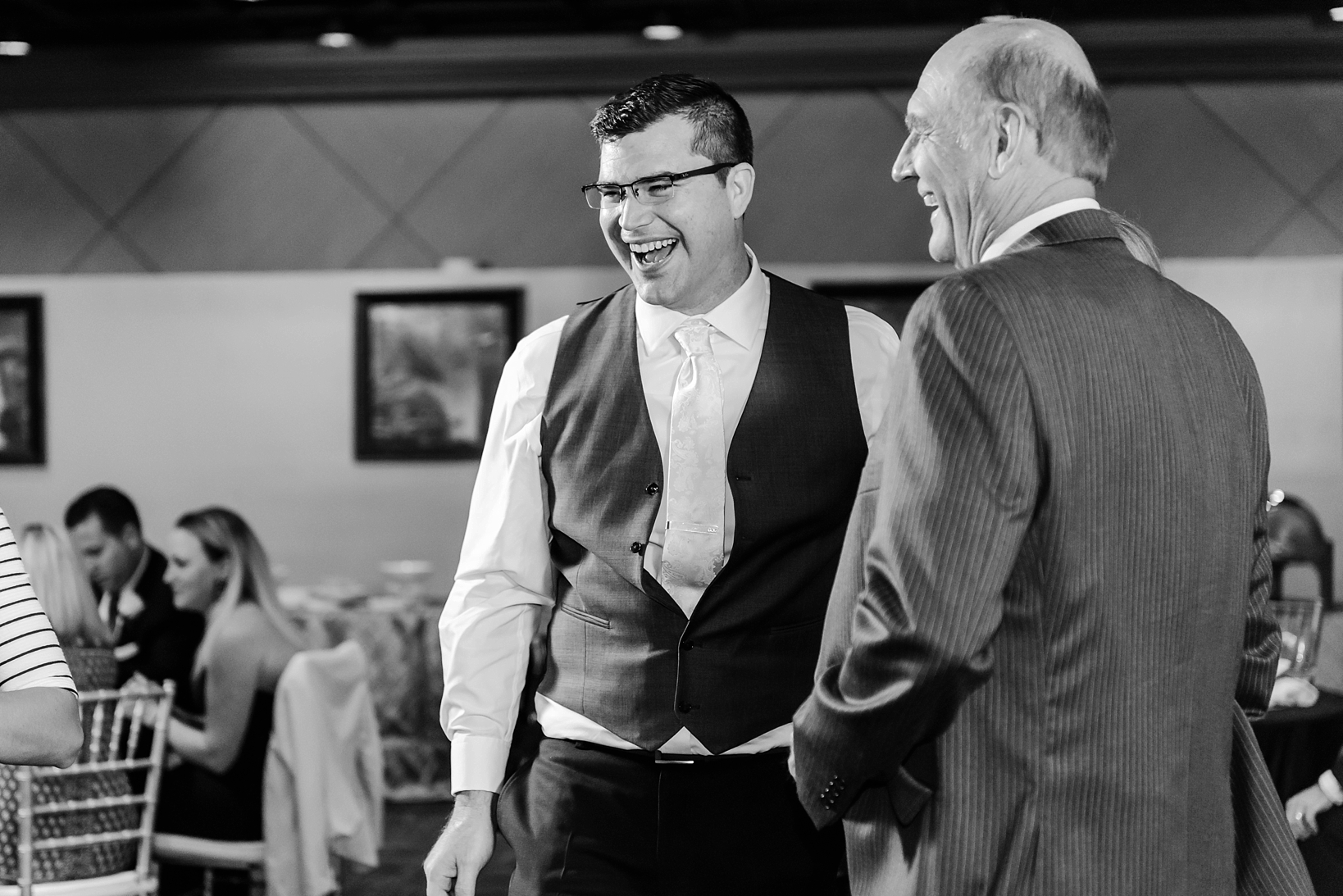 Groom laughing along with a Guest during the dancing