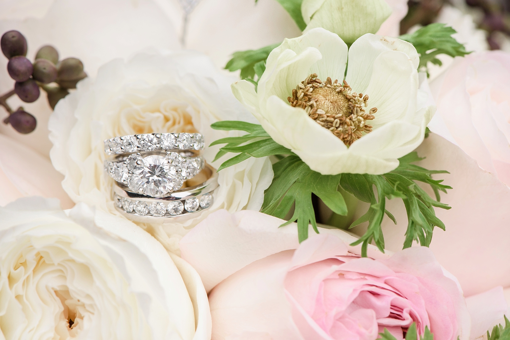 Close-up of wedding rings on the brides bouquet