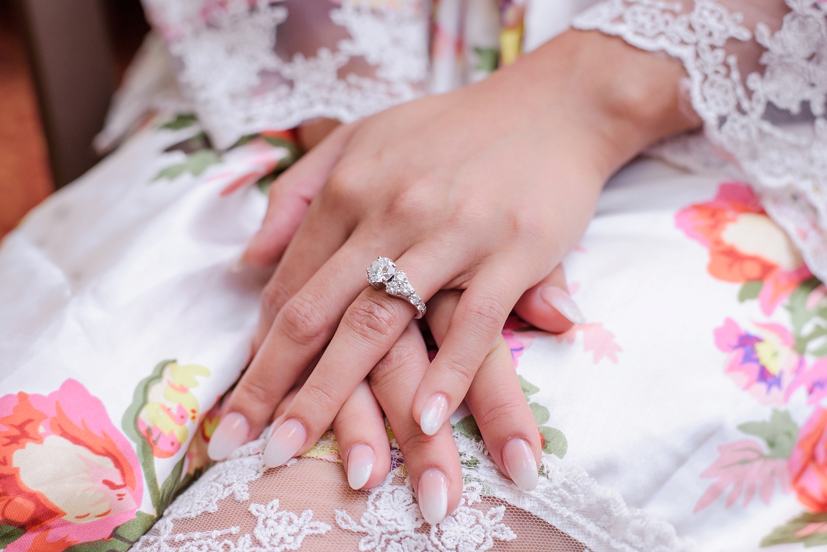 The bride's hand with her engagement ring