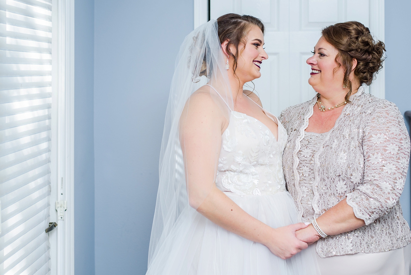 Mother and Daughter on the wedding day smiling at each other