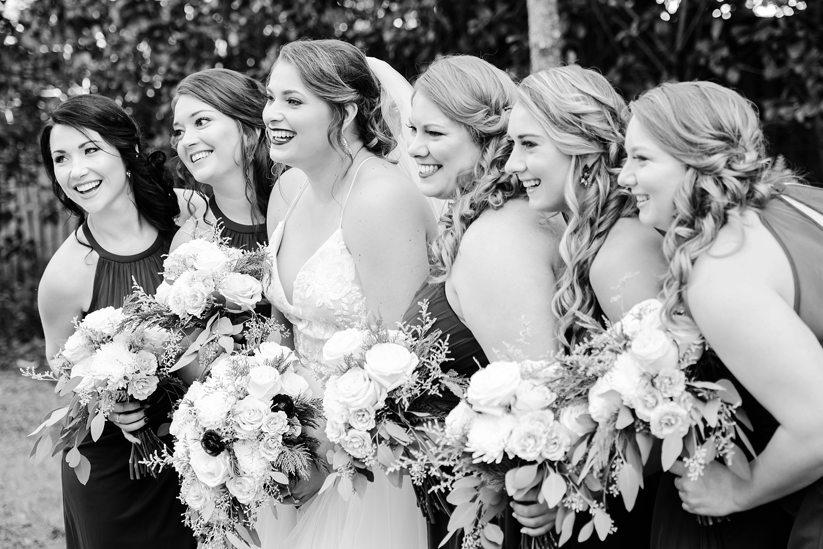 Black and White image of the Bride and the Bridesmaids laughing by Sarah & ben