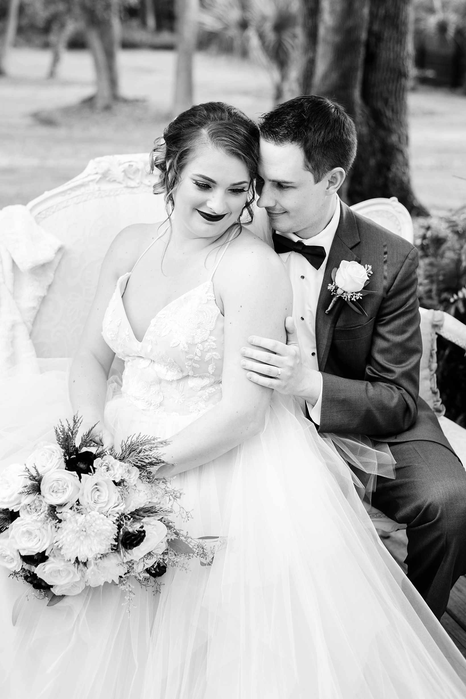 Bride and Groom in black and white sharing a quiet moment together after their ceremony