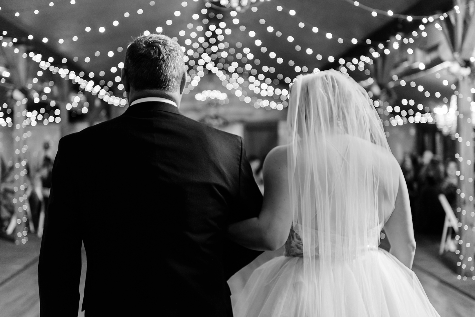Father and Daughter dance during the reception surrounded by string lights everywhere