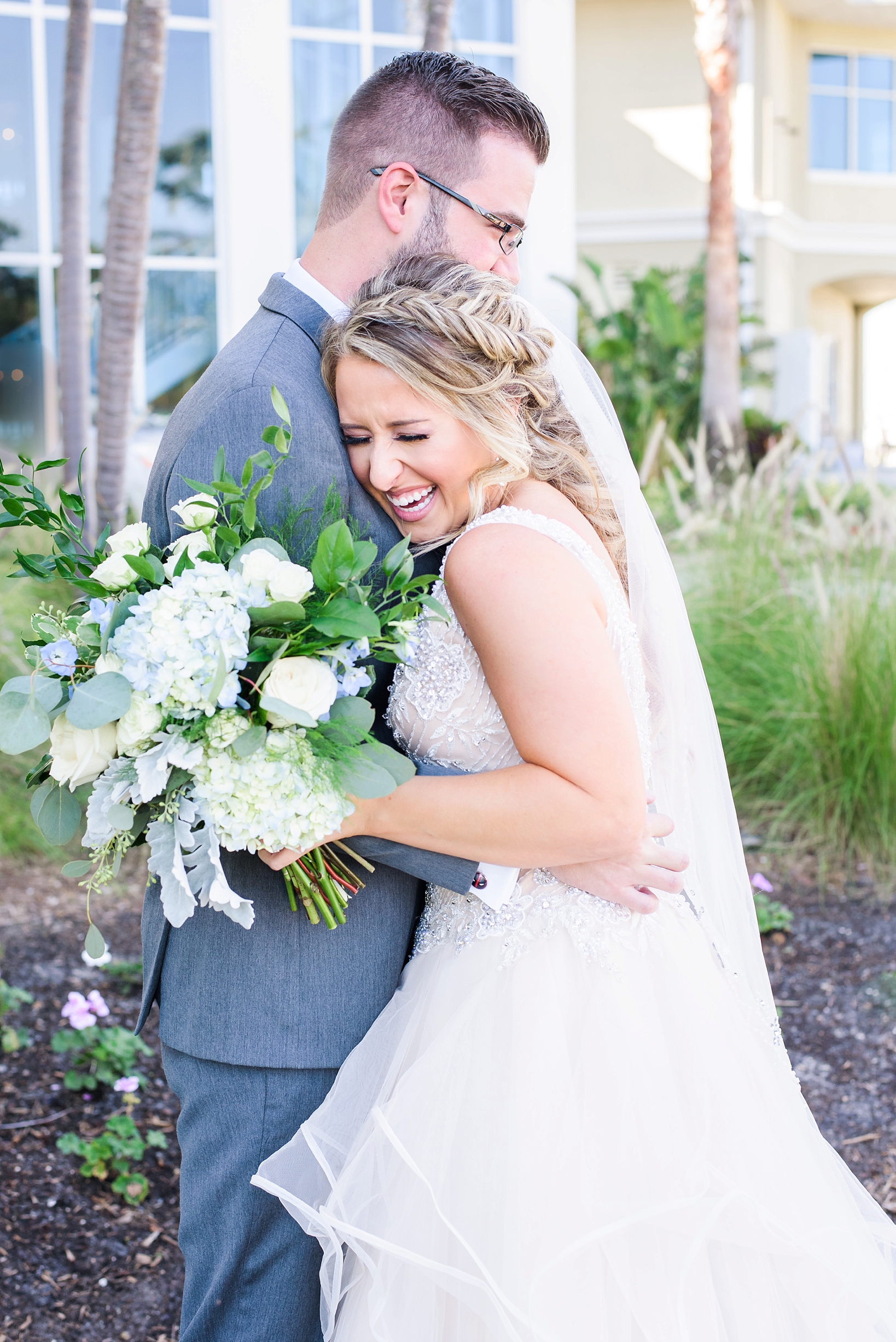 Bride laughs during an embrace with her Groom in Tampa, FL by Sarah & Ben Photography