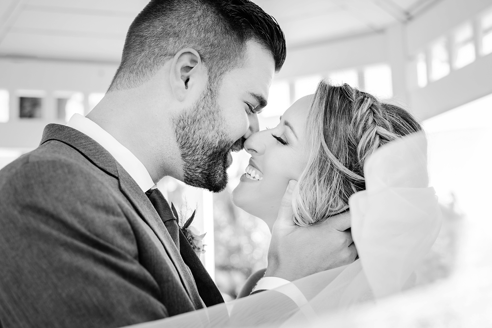 Black and white photo of a lovely moment between a bride and groom by Sarah & Ben Photography