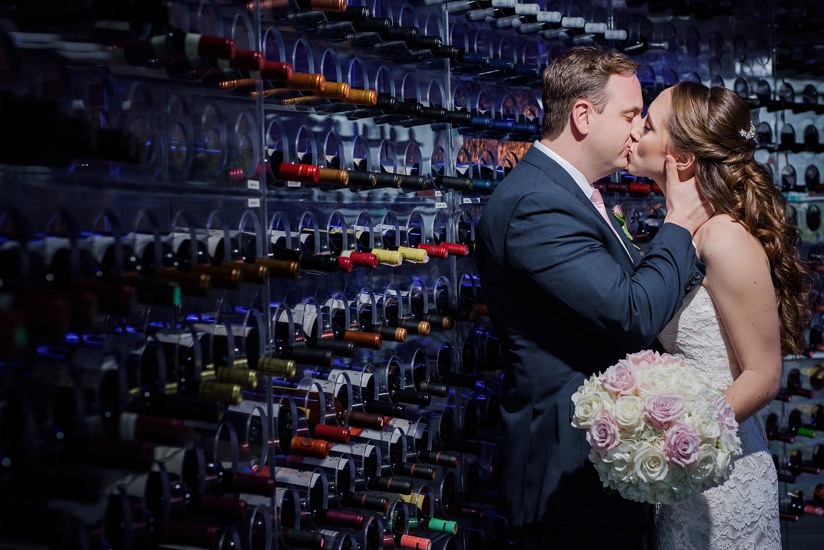 Bride and Groom kissing in the custom wine cellar at the Westin Tampa Bay by Sarah & Ben Photography