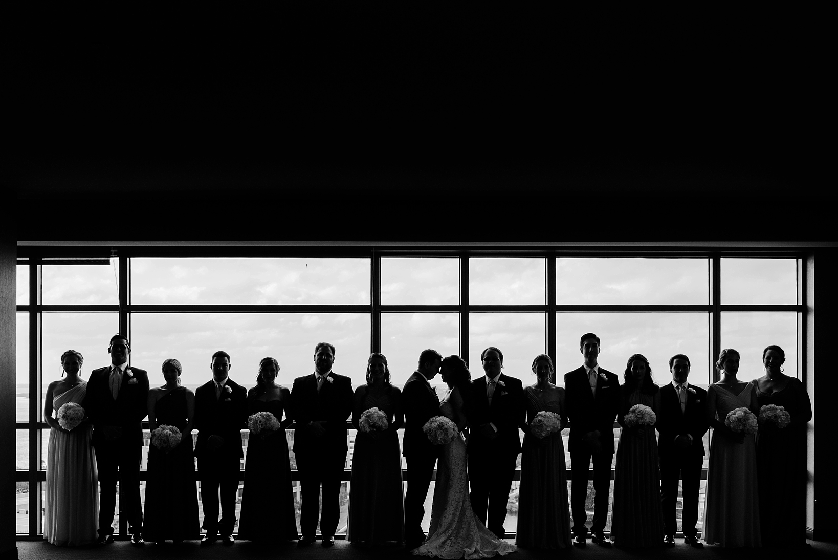 Black and white silhouette of the complete bridal party by Sarah & Ben Photography