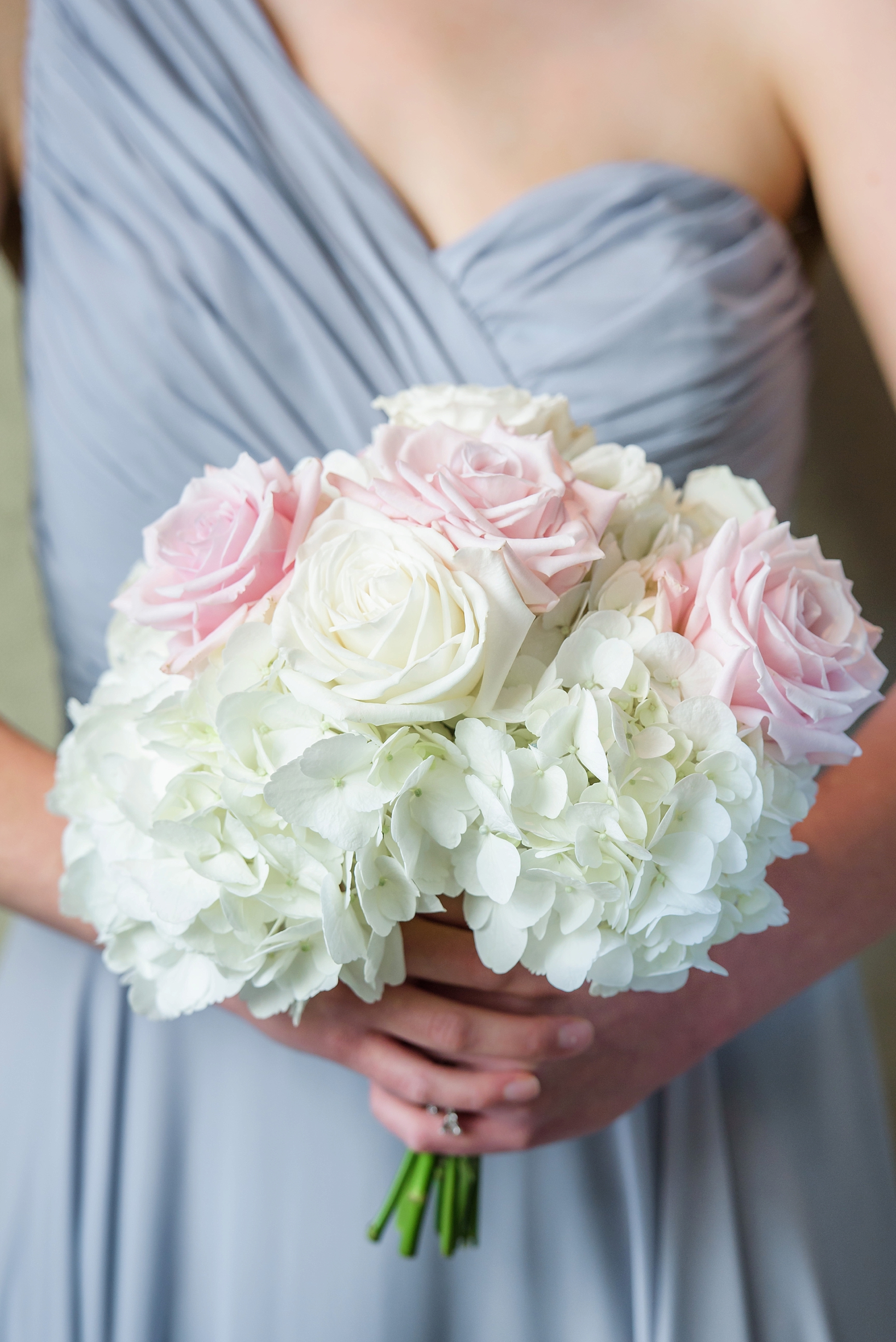 Bridesmaids floral bouquet close up filled with hydrangeas and roses