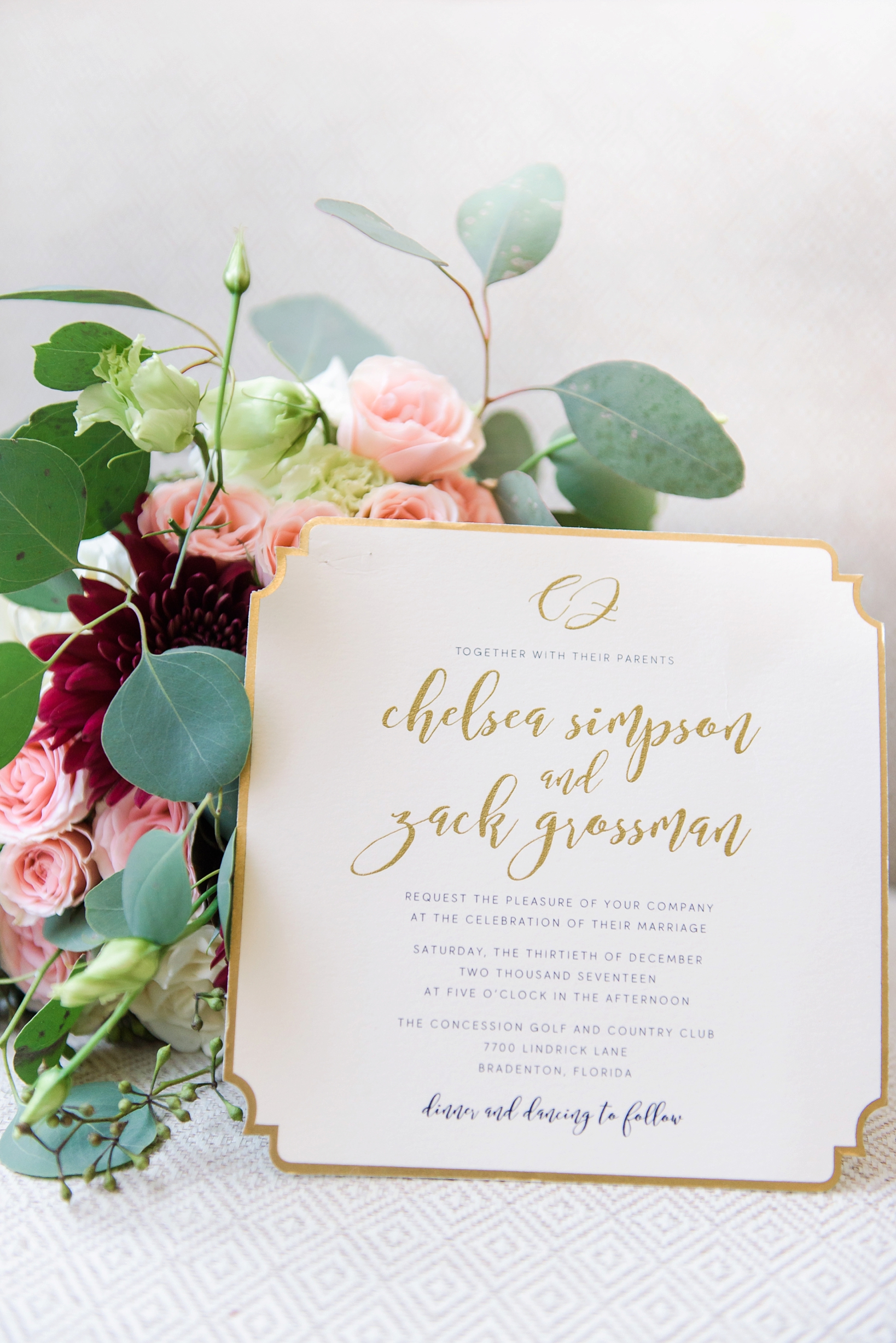 Gold foil invitation with bride's floral bouquet