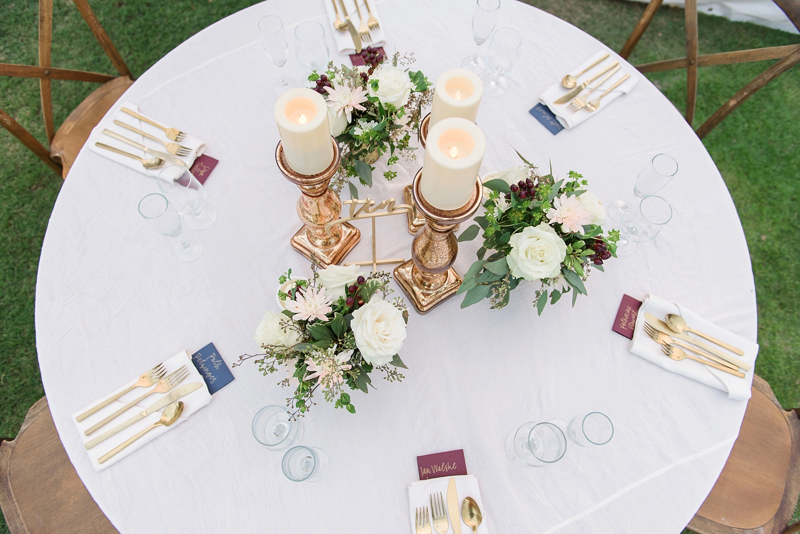Simple gold candelabras and floral centerpieces decorated the tables with gold utensil accents