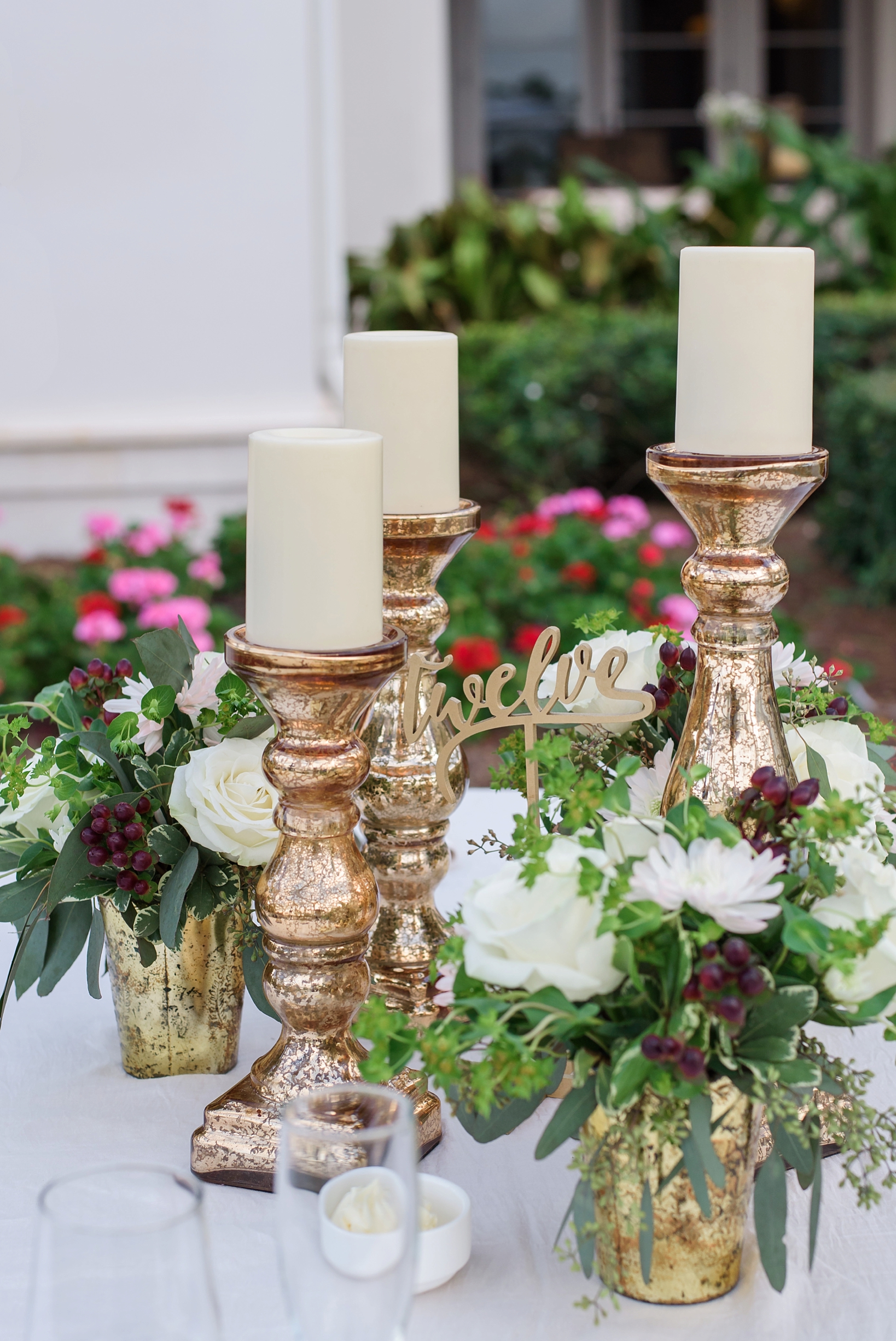 Floral centerpieces with a mixed assortment of candles