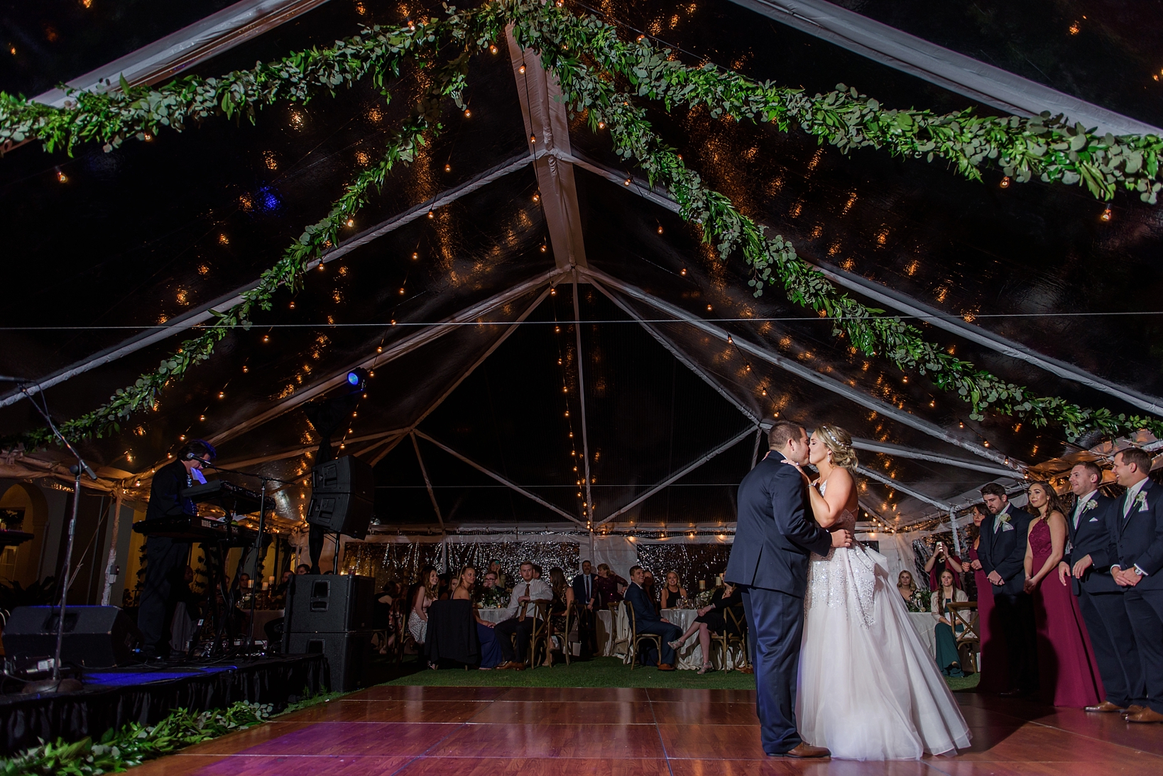 The end of the First Dance by the Bride and Groom under the Floral garland and string lights