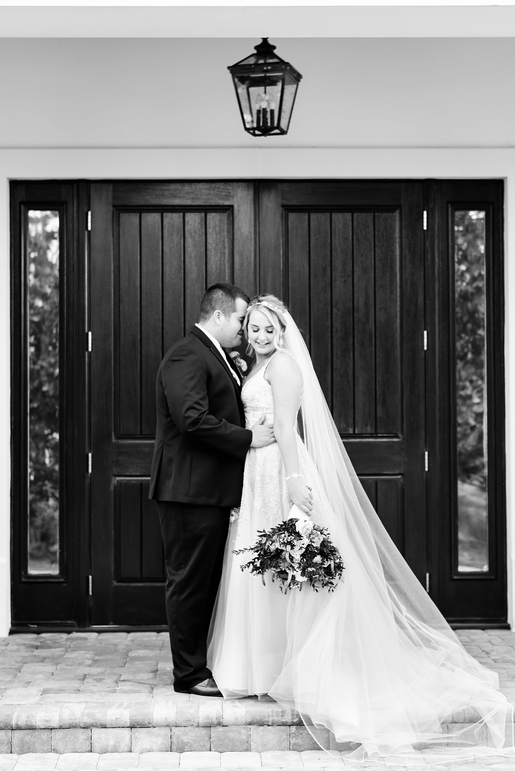 Black and white portrait of the Bride and Groom under a lantern