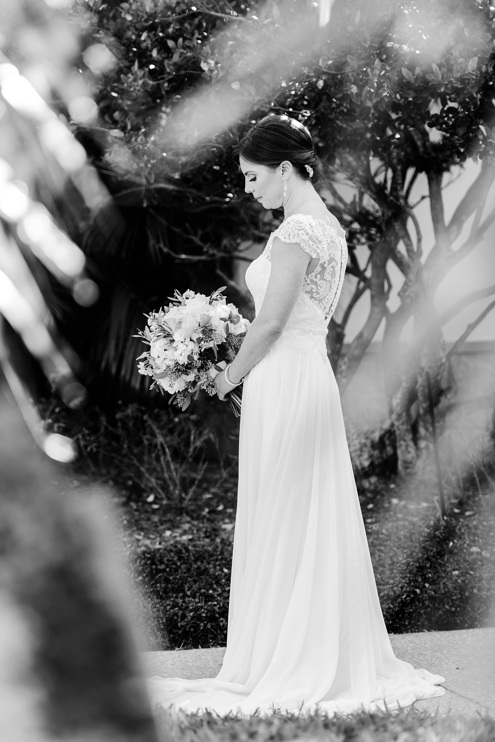 The bride surrounded by ferns in black and white