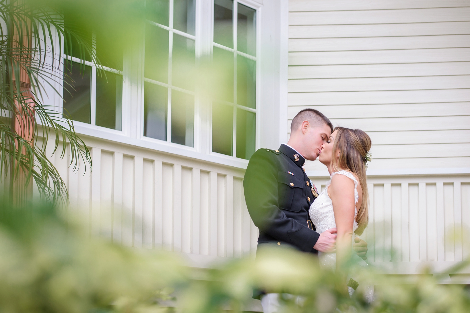 Bride and Groom kissing in front of their venue