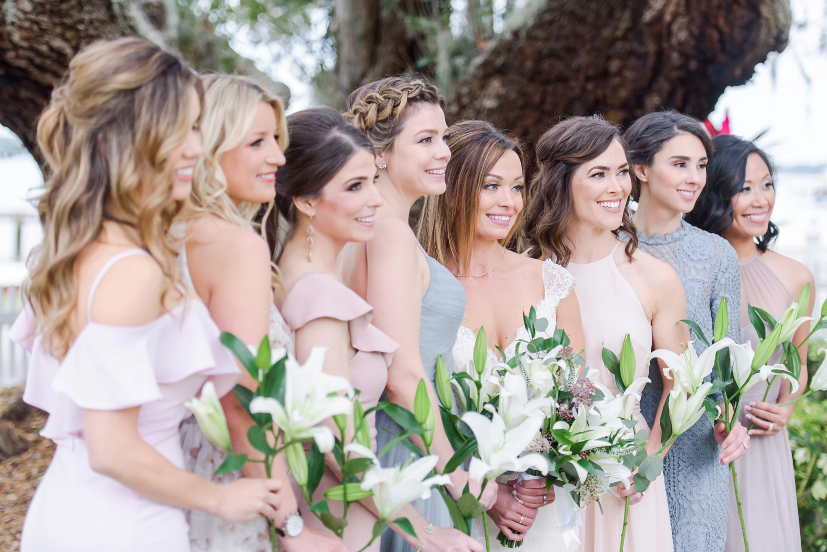 Bridesmaids each holding a single stargaze lily
