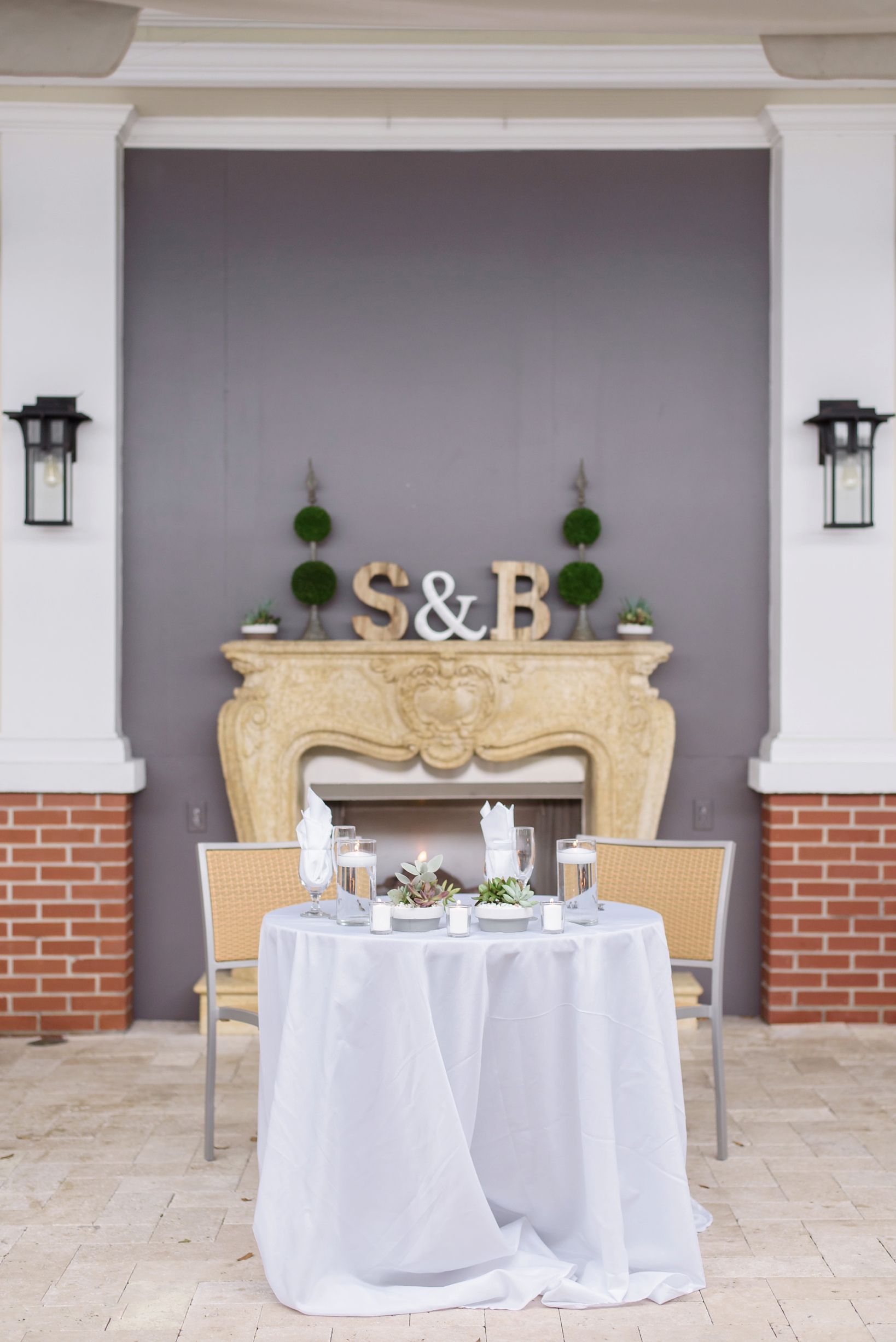 Bride and Groom's sweetheart table in front of the fireplace at the palmetto riverside BnB 
