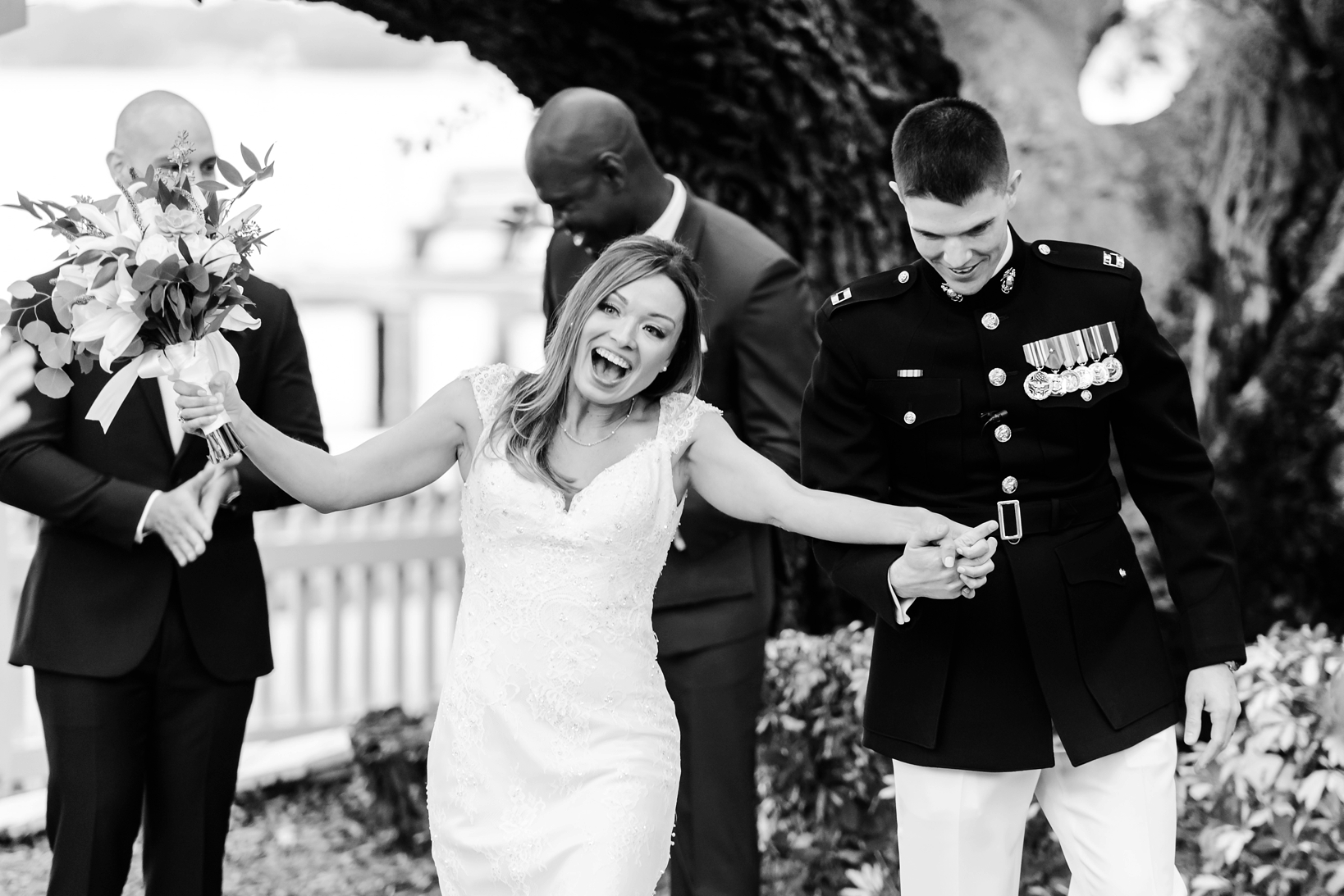 Bride celebrating as she walks back up the aisle with her new husband