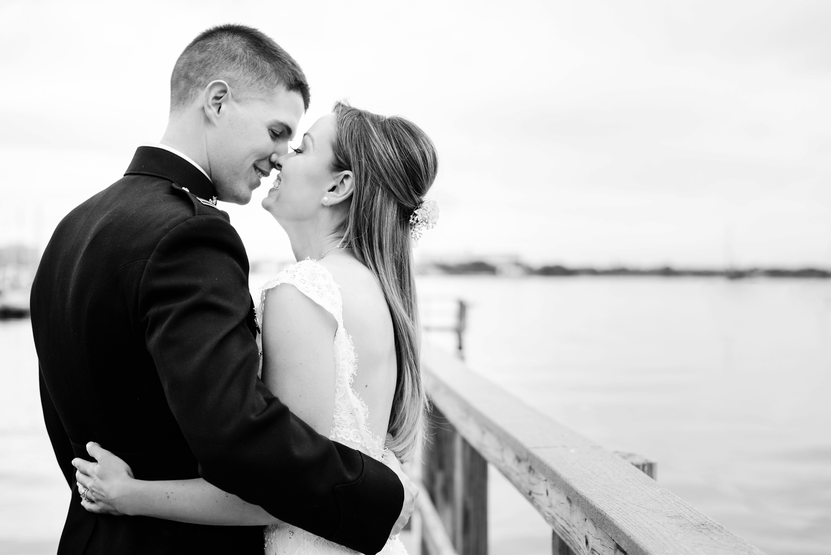 Bride and Groom laughing on the dock by Sarah & Ben Photography