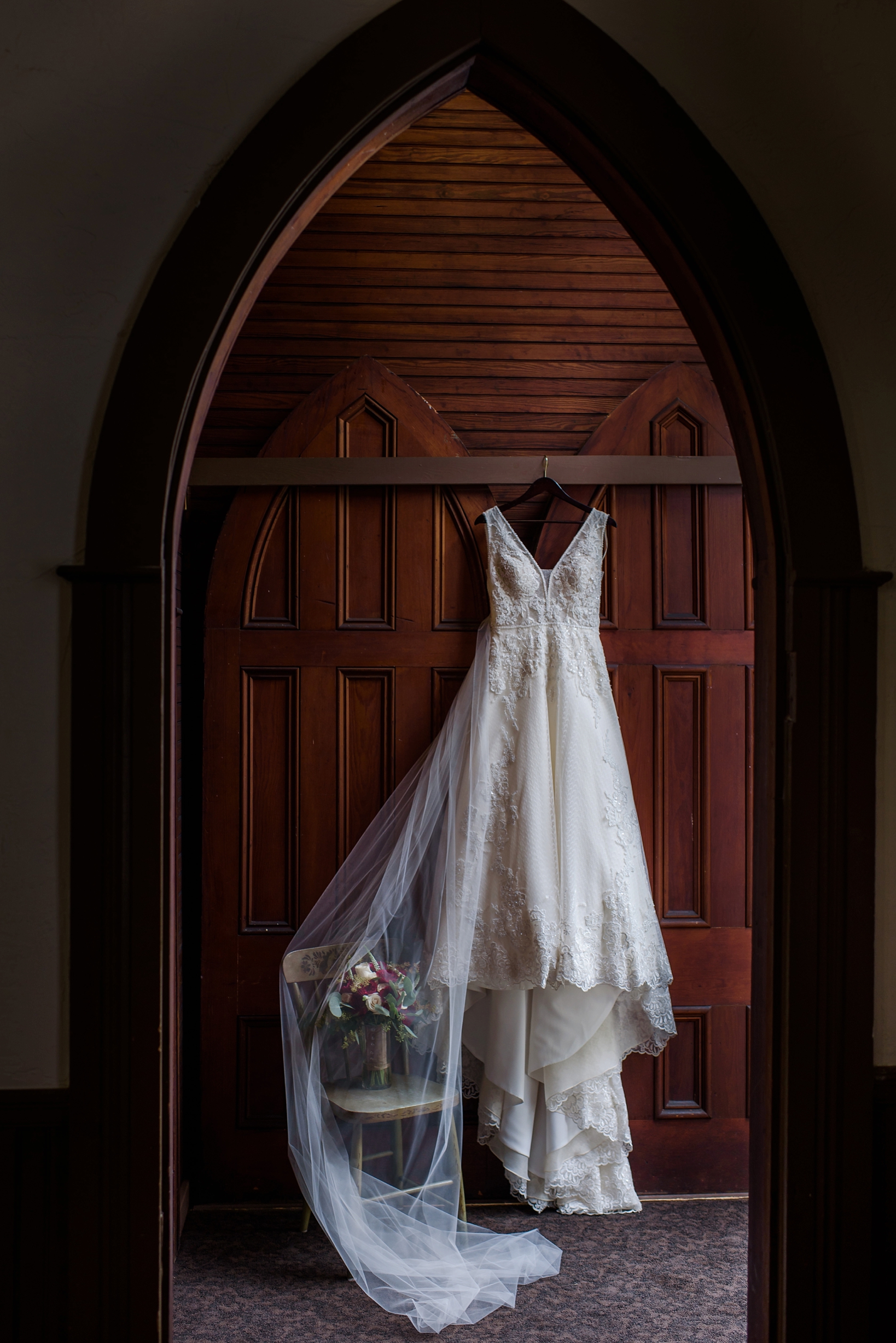 Bride's Wedding Dress hanging in Andrews Memorial Chapel in Dunedin, Florida by Sarah & ben Photography. by Sarah & Ben Photography. Check out all our work at www.sarahben.com