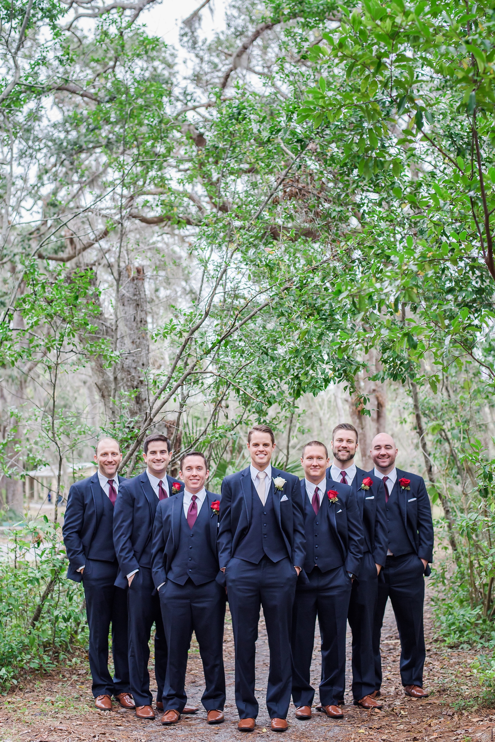 Groom and his Groomsmen in a traditional group shot with greenery all around by Sarah & Ben Photography. Check out all our work at www.sarahben.com