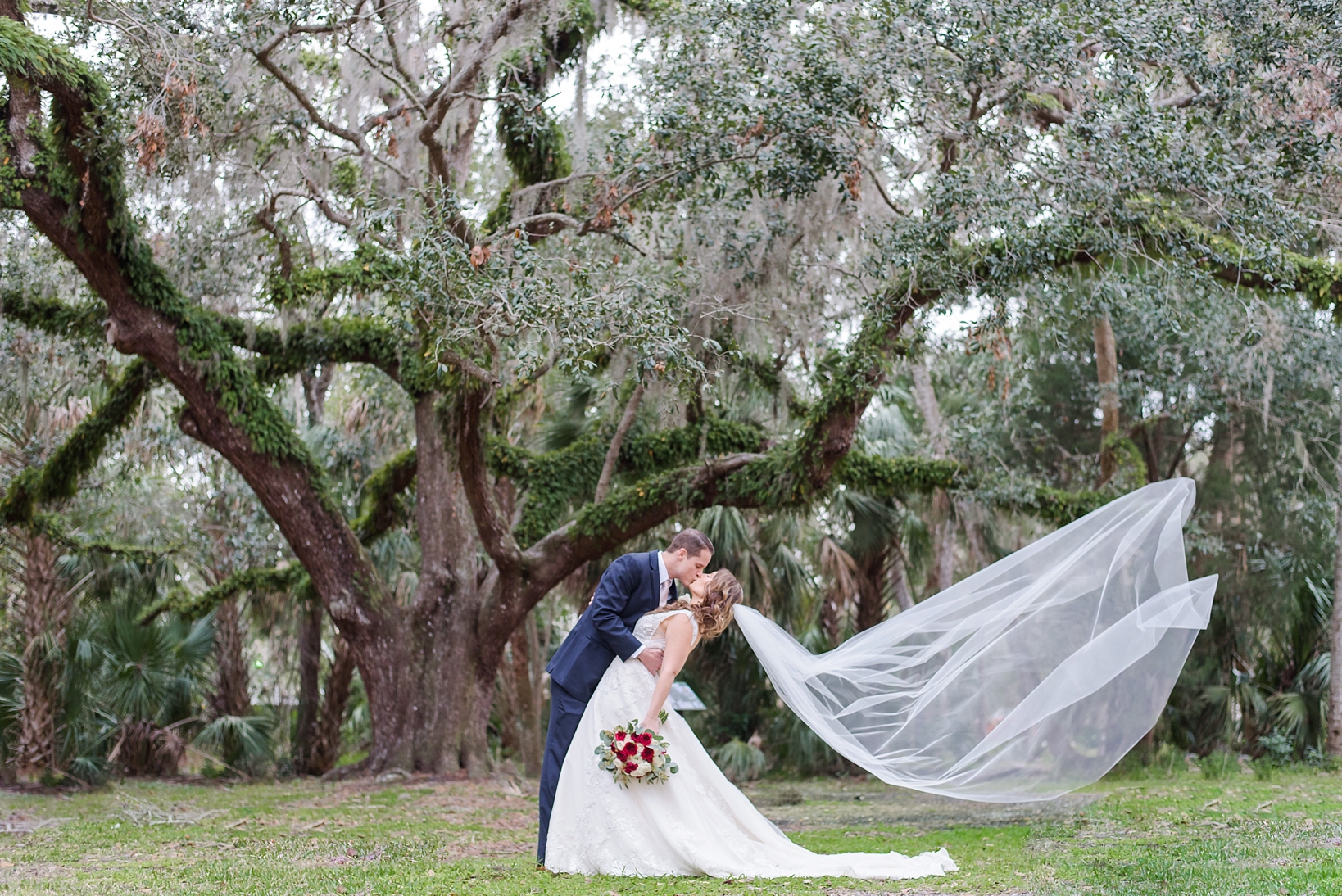 Epic shot of the wind catching the brides veil by Sarah & Ben Photography. Check out all our work at www.sarahben.com