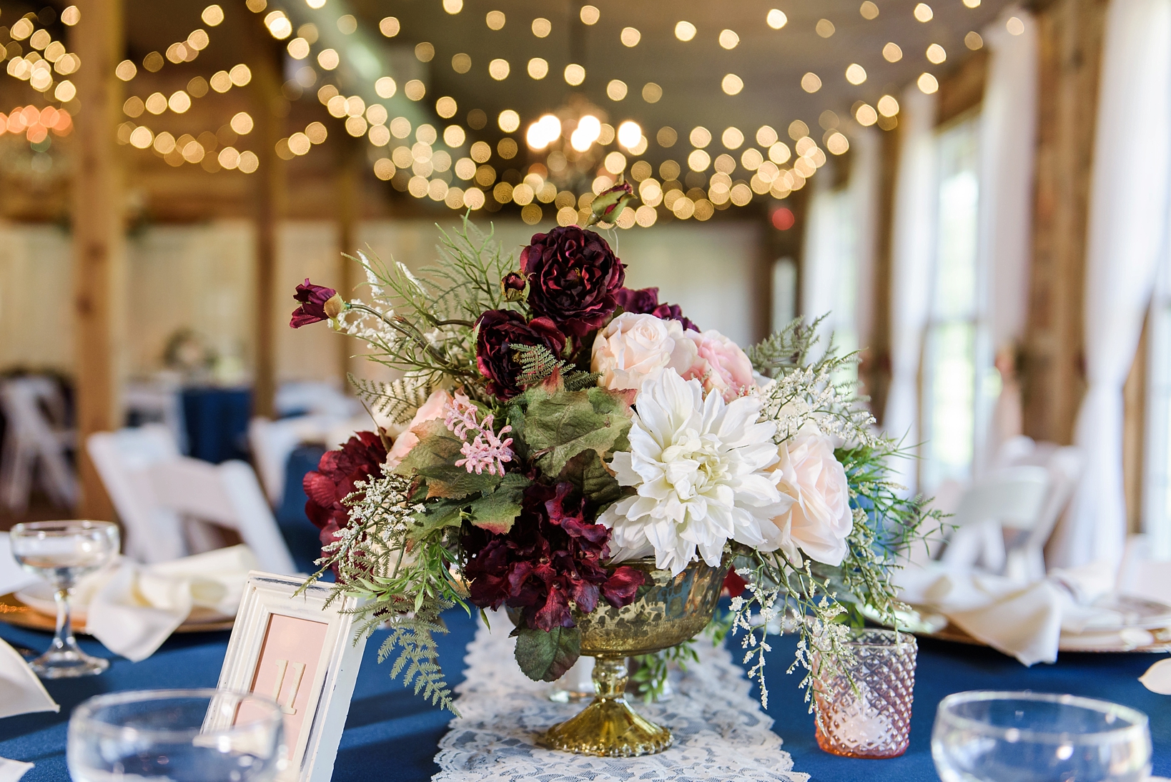 Short floral centerpiece with string lights