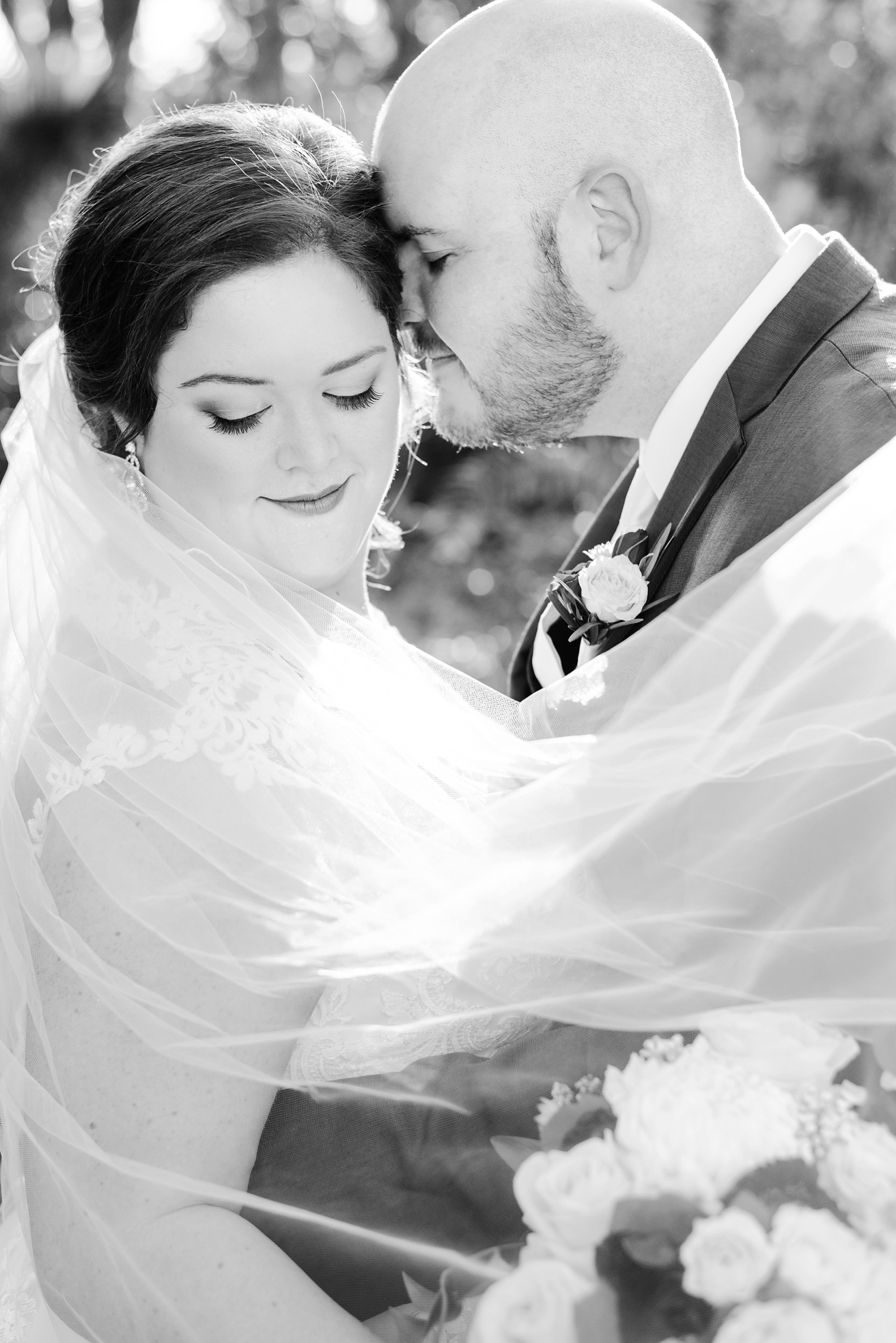 Black and White wedding photo with veil blowing in the wind