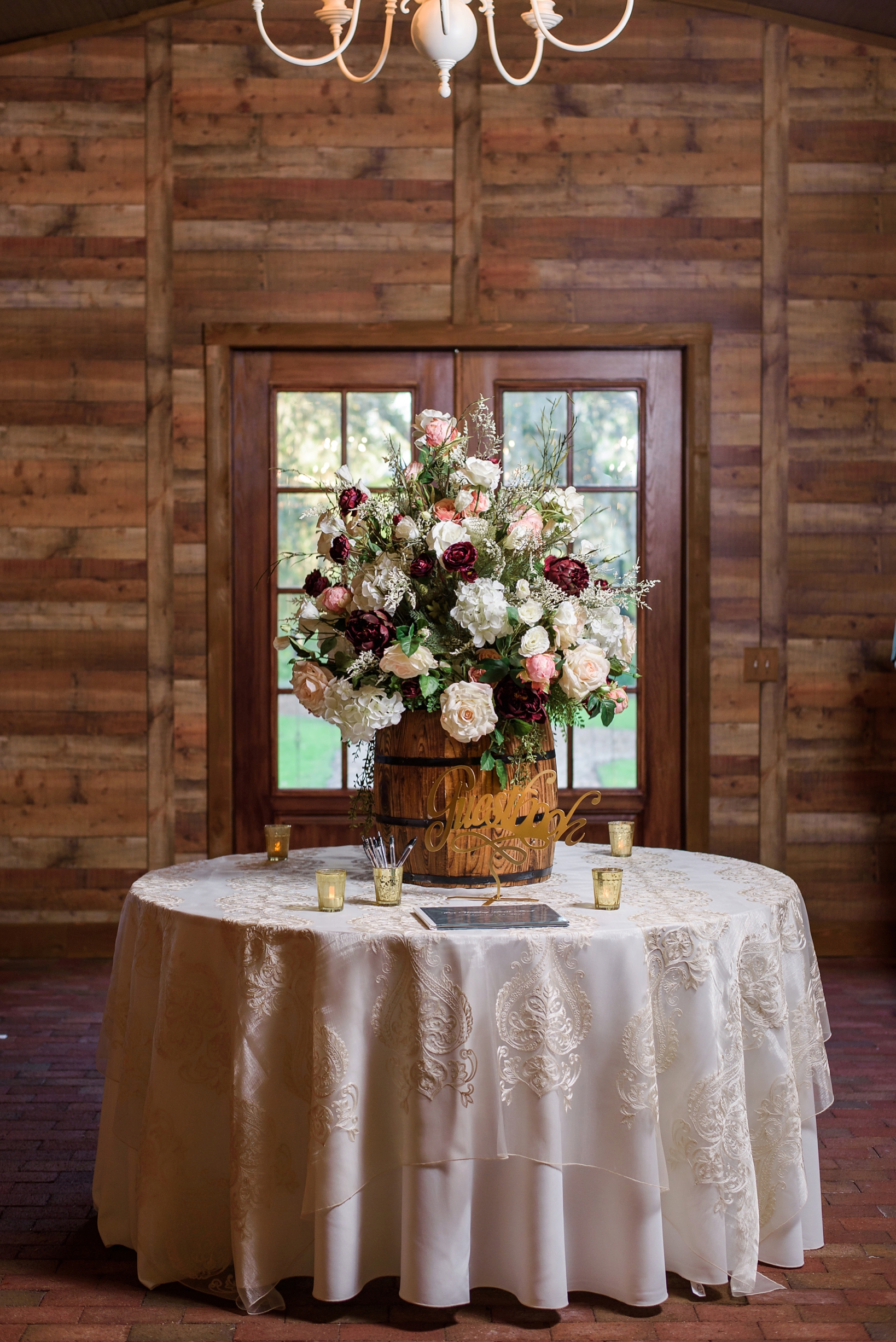 Guestbook table with rustic barrel accents by Sarah & Ben Photography
