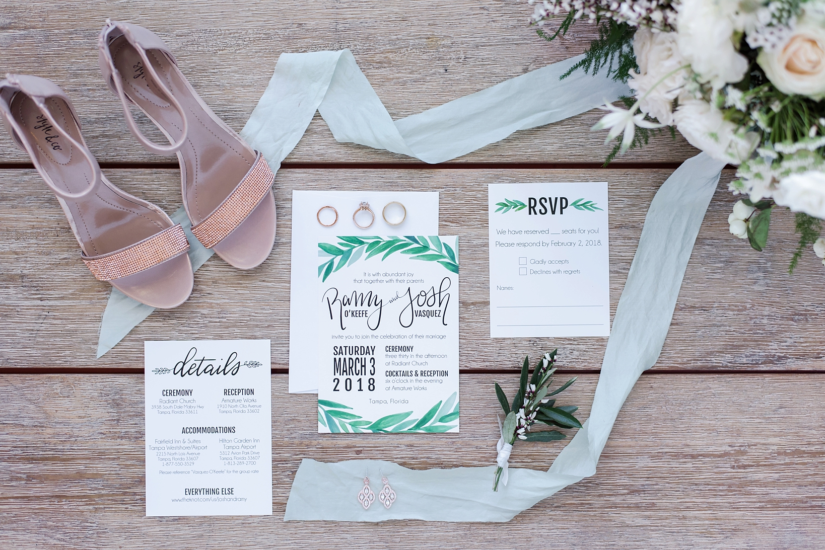 Wedding invitation suite with fern accents and rustic wood background