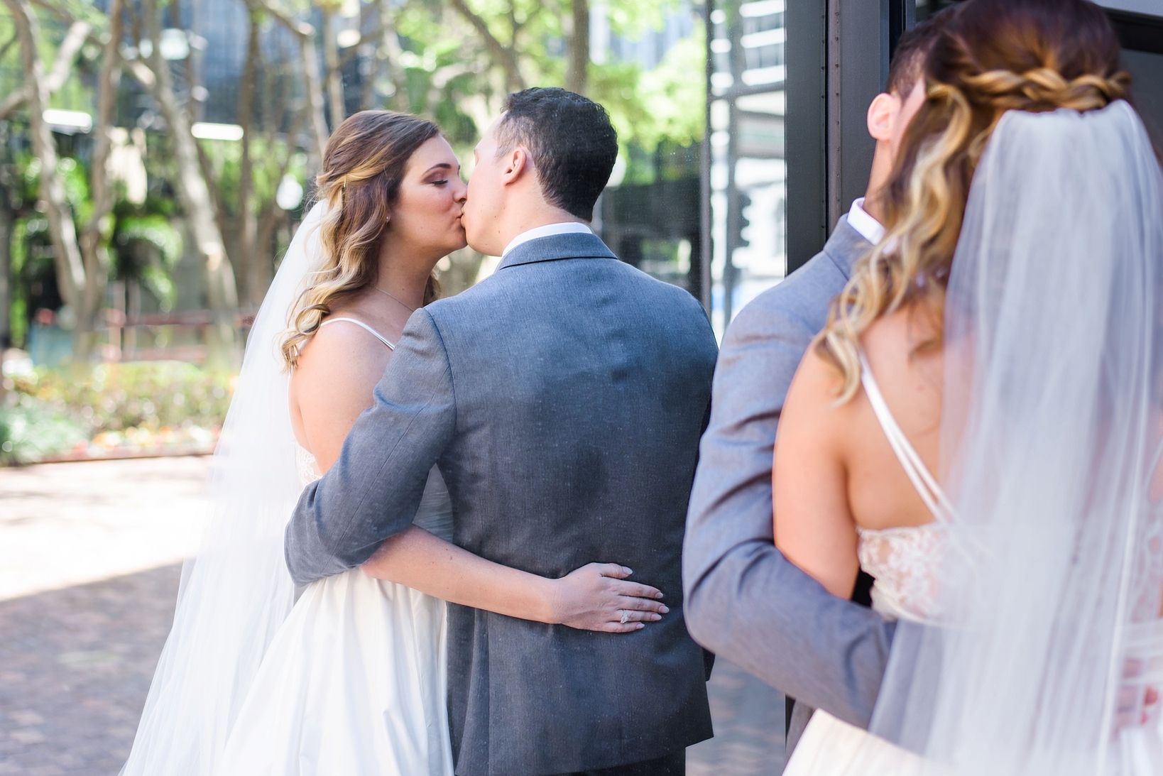 Bride and groom kissing in a reflection by Sarah & Ben Photography