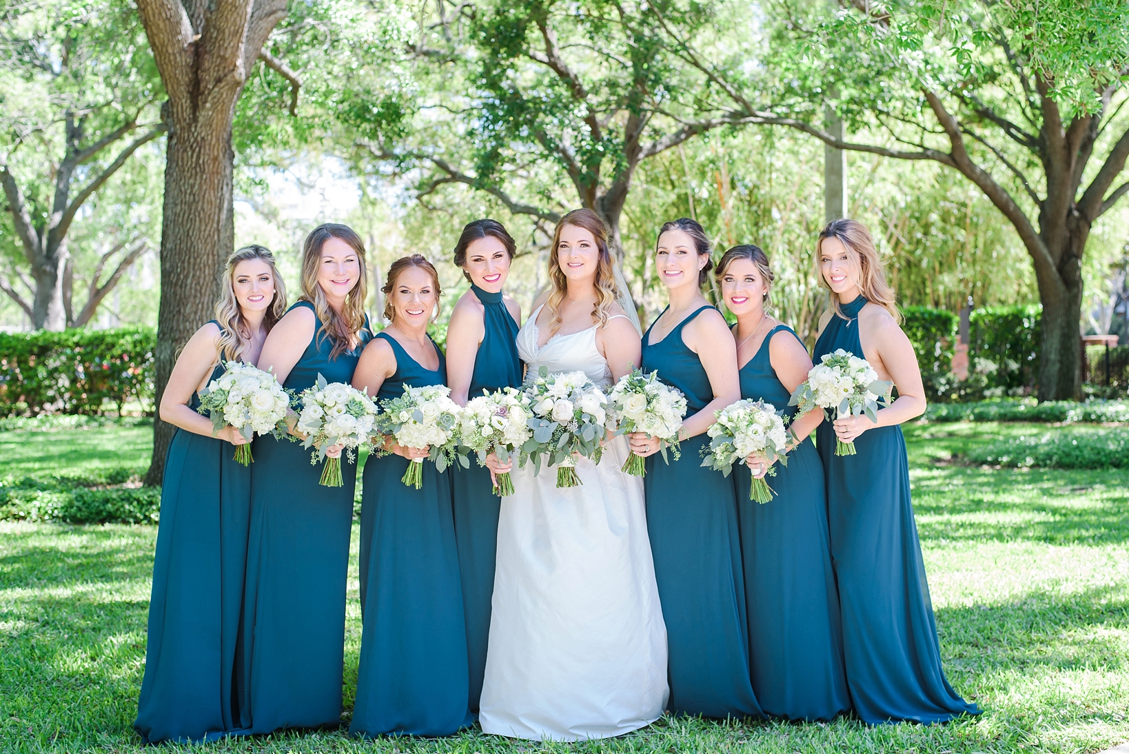 Bride and her bridesmaids in the park at the University of Tampa gardens by Sarah & Ben Photography