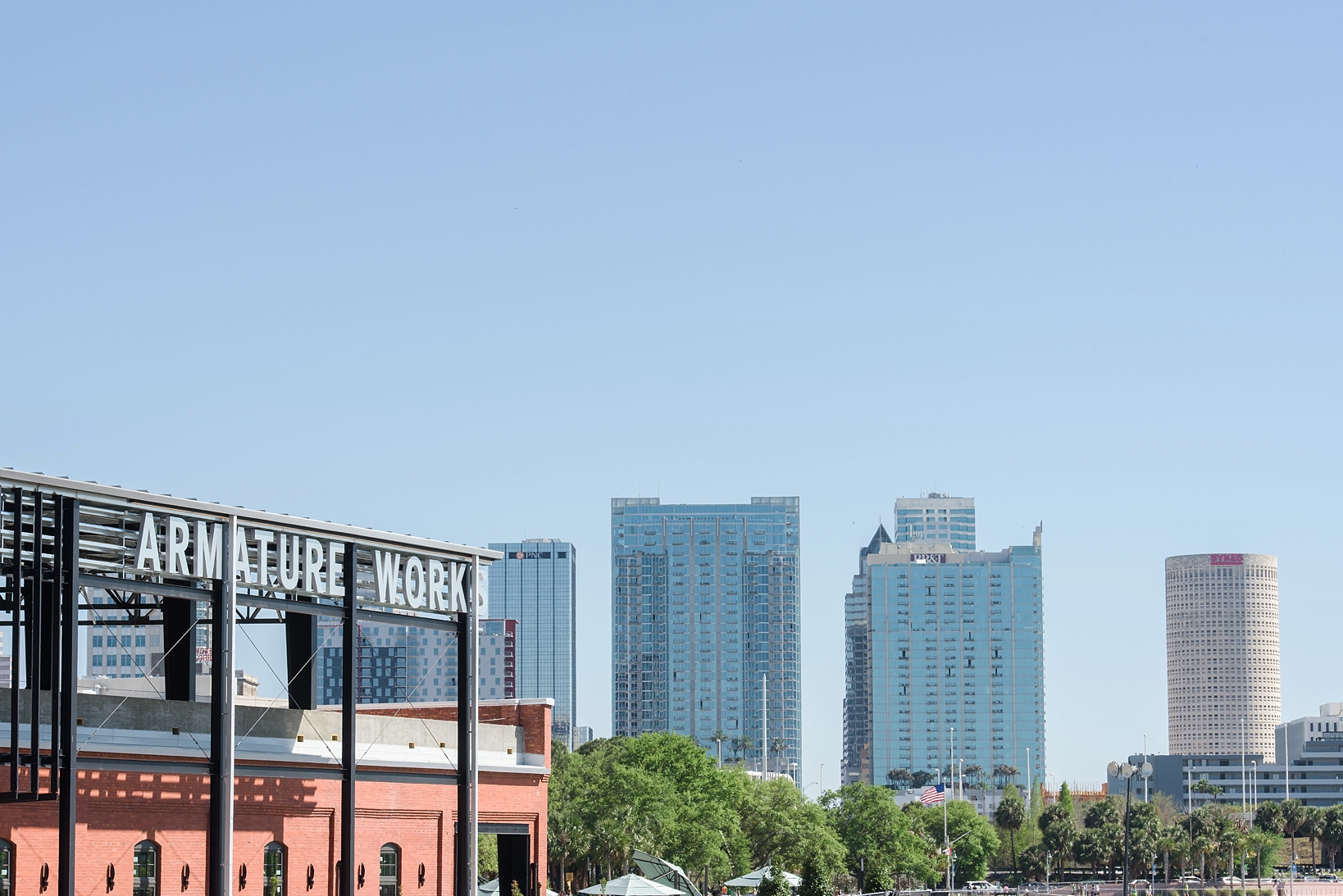 Tampa skyline with Armature Works logo and building in the forefront by Sarah & Ben Photography