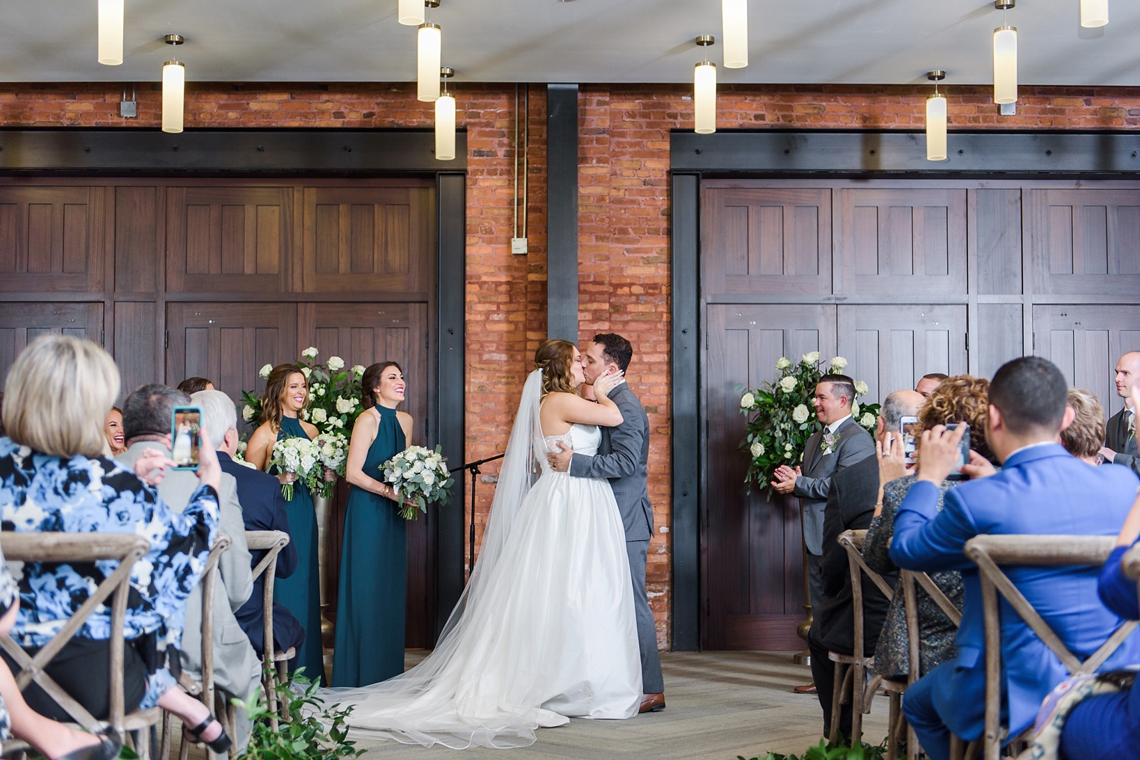 The first kiss between the bride and groom by Sarah & Ben Photography