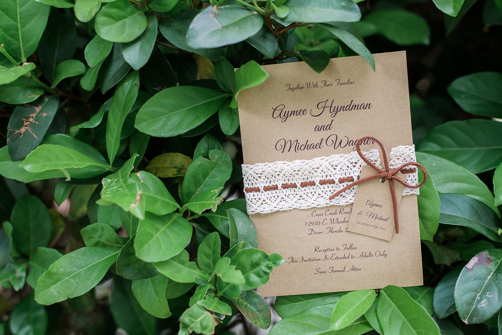 Wedding invitation with lace wrap and leather accents