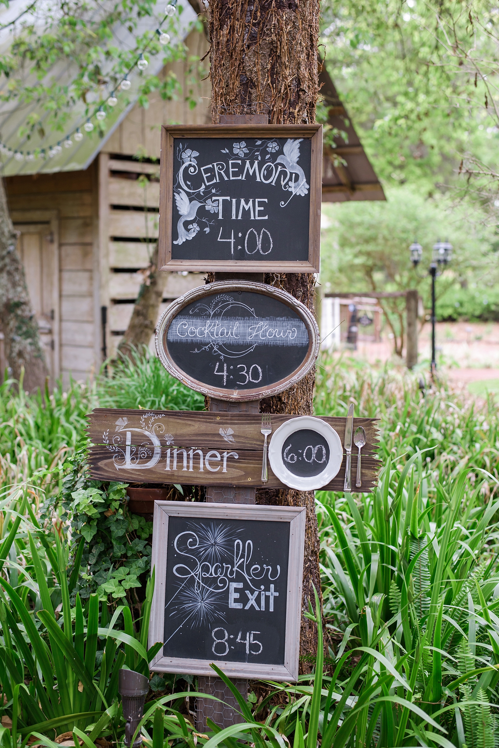 Rustic schedule at Cross Creek Ranch with chalkboard signs on a tree
