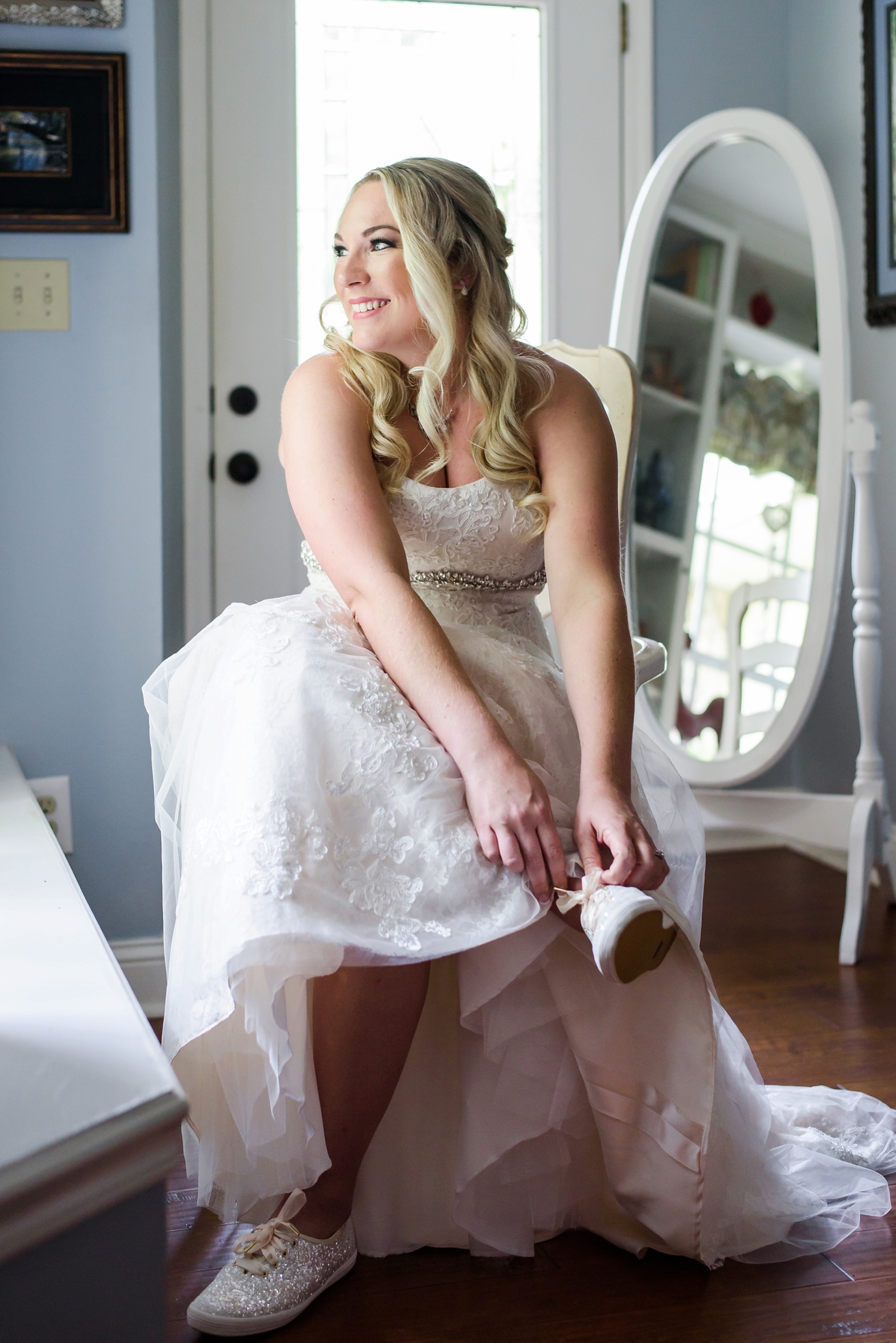 Bride putting on her Kate Spade shoes for dancing during the cross creek ranch reception