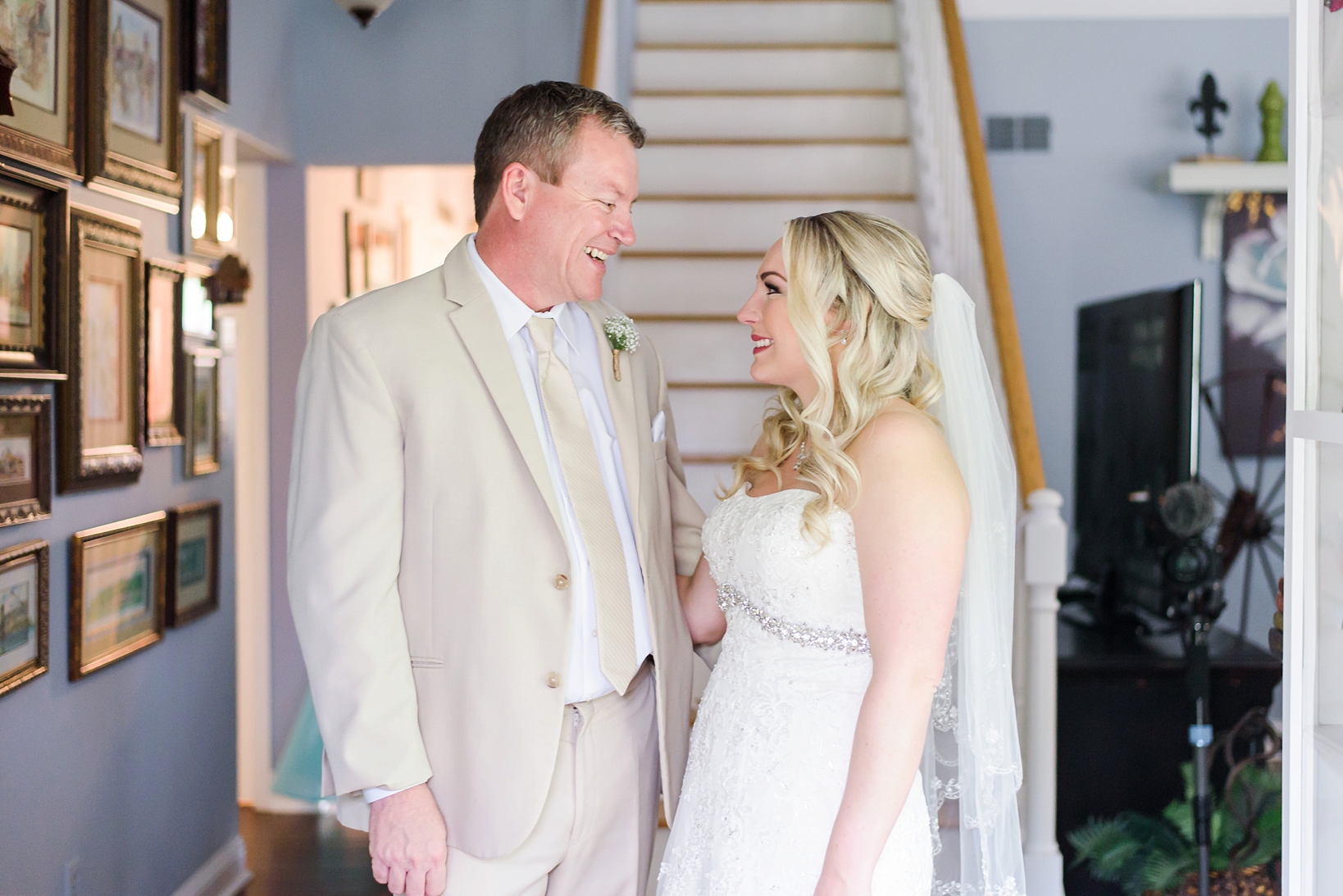 Bride and her father laughing before the wedding ceremony