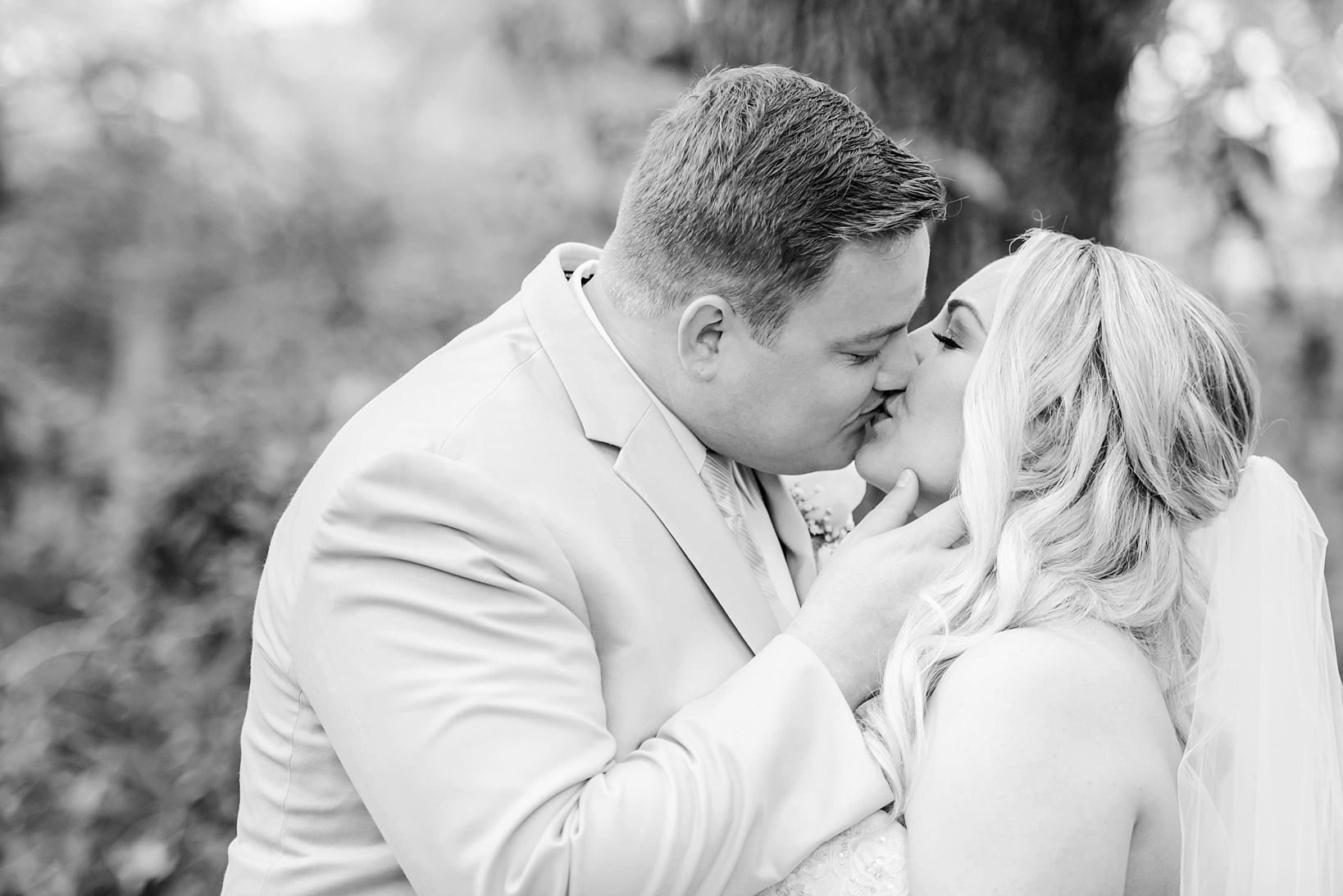Bride and Groom kissing in a timeless wedding portrait after their ceremony and before their cross creek ranch wedding reception