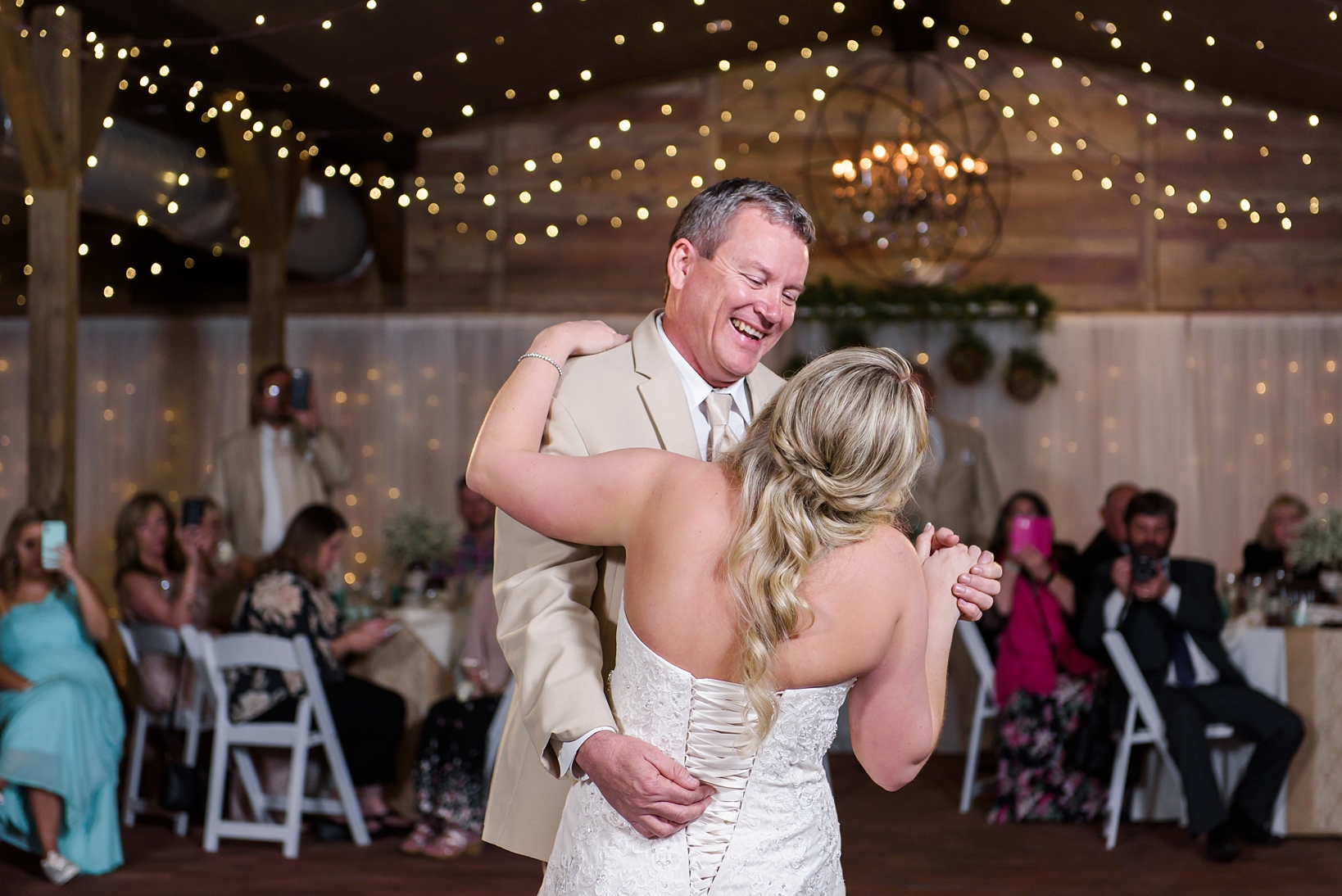Father Daughter dance during the cross creek ranch reception under the string lights of the Barn