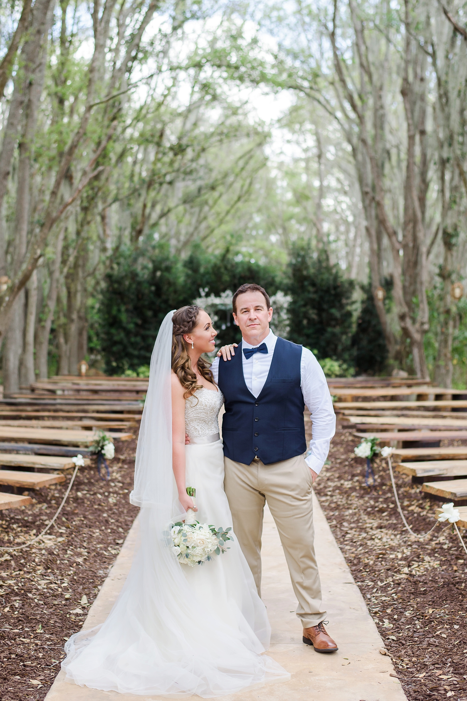 Bride and Groom standing in the aisle of their ceremony by Sarah & Ben Photography