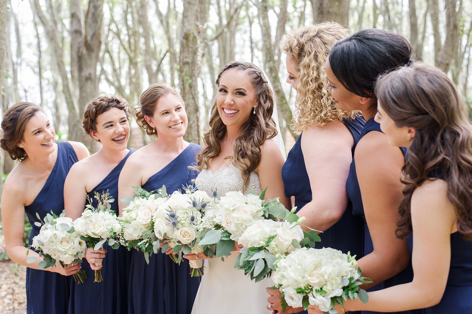 The Bride and her Bridesmaids smiling in the rustic forests of Plant City, FL